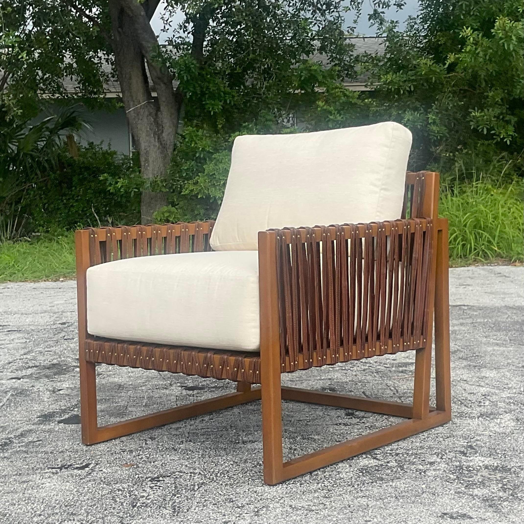 A fabulous vintage Boho lounge chair. Made by the iconic Palecek group. The chic “Commodore” design with wood frame and leather strap detail. Tagged on the bottom. Acquired from a Palm Beach estate. 