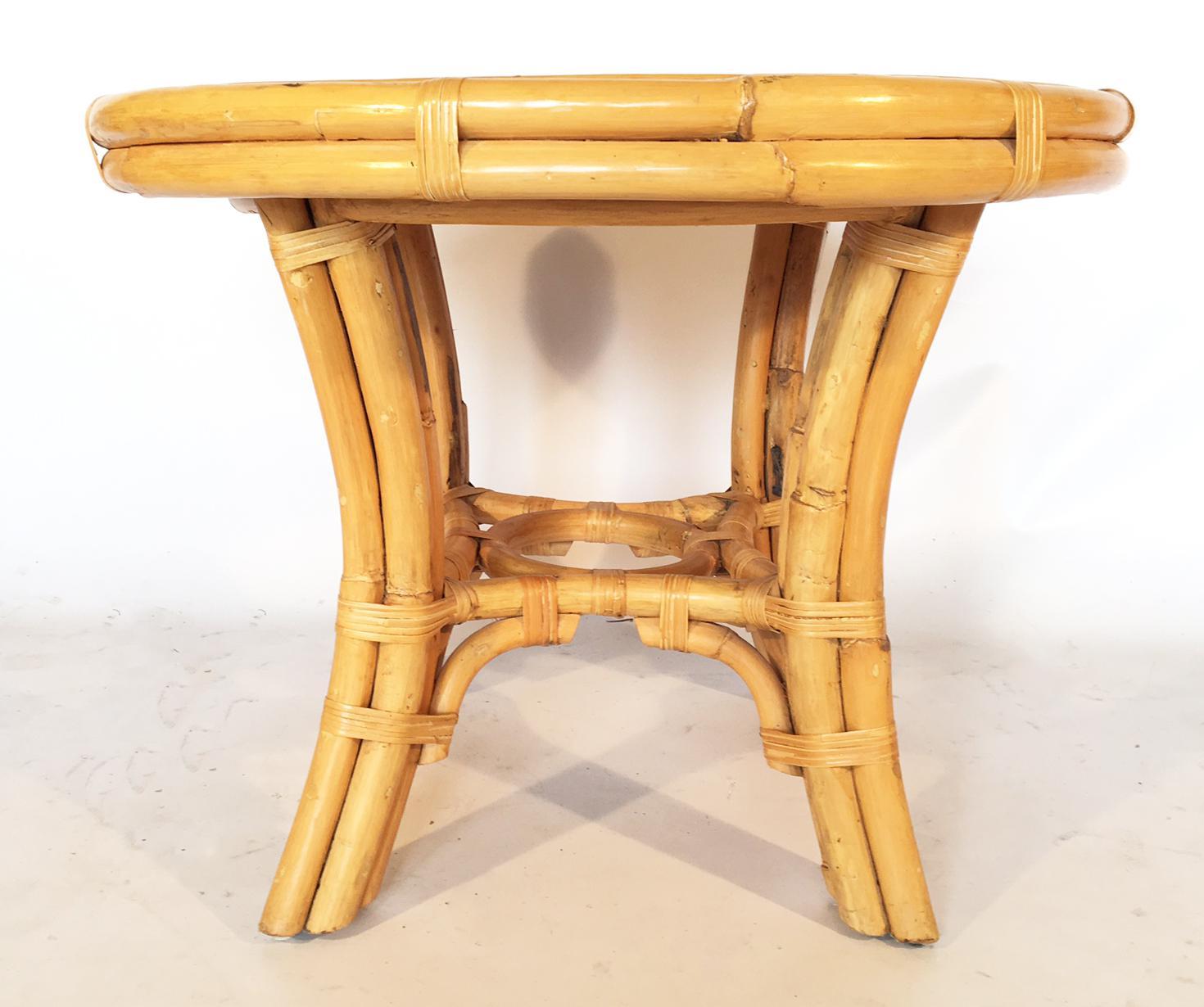 Table features carefully crafted cane surface encased with a rattan frame and base.
Very good vintage condition with minimal wear consistent with age.