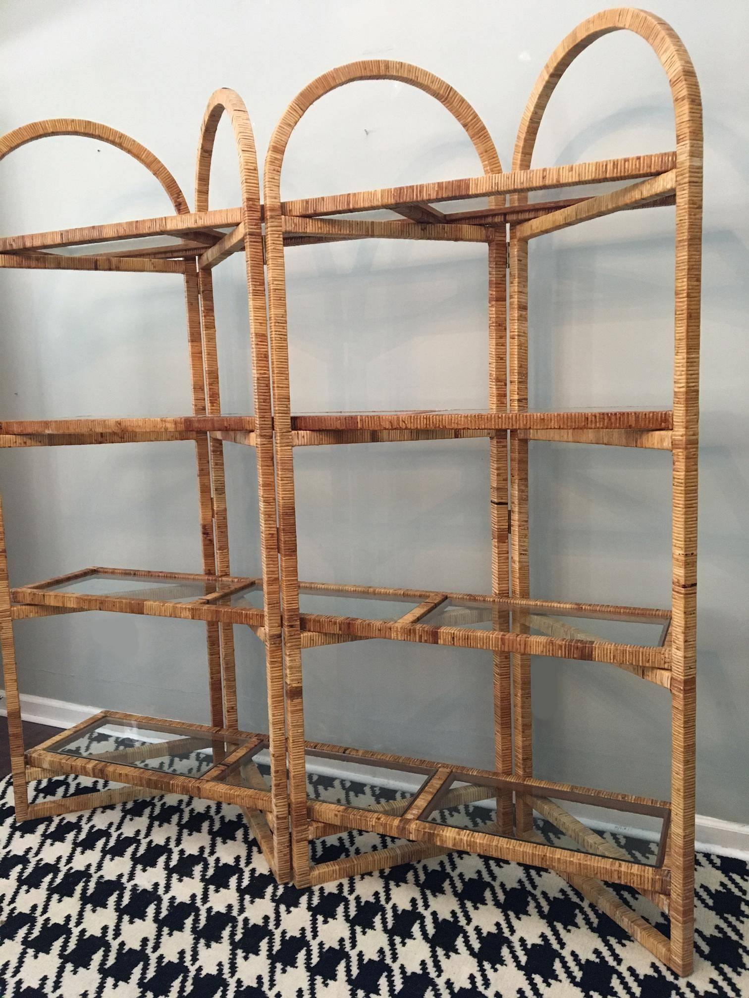 Palm Beach styling abounds with this large rattan étagère. Four panels unfold to support four shelves with glass inserts. Stands 78