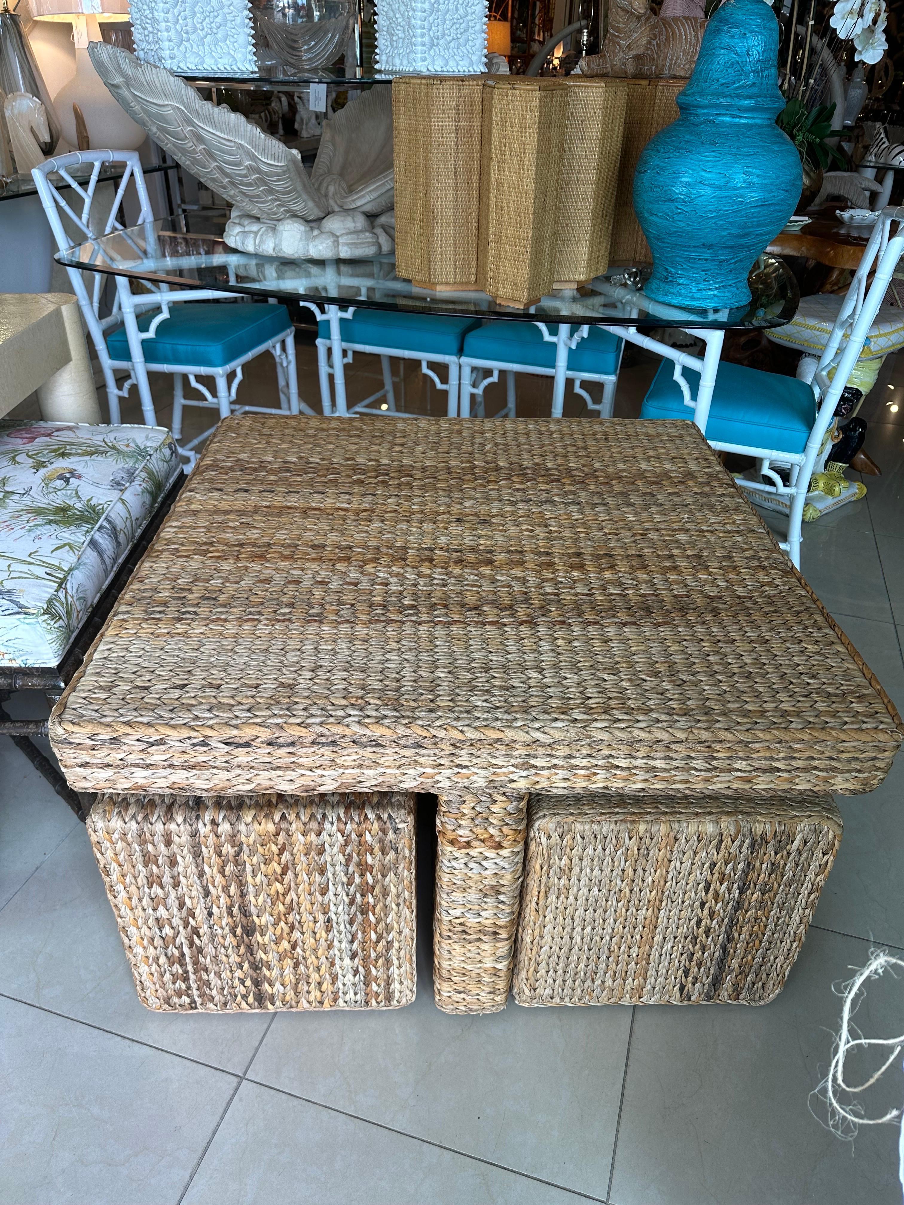 Wonderful vintage seagrass coffee cocktail table with 4 benches stools that tuck underneath for storage. Such a great space saver! Benches and coffee table have new feet/bumpers put on. No damage. Table dimensions: 22 H x 38 W x 38 D. Benches