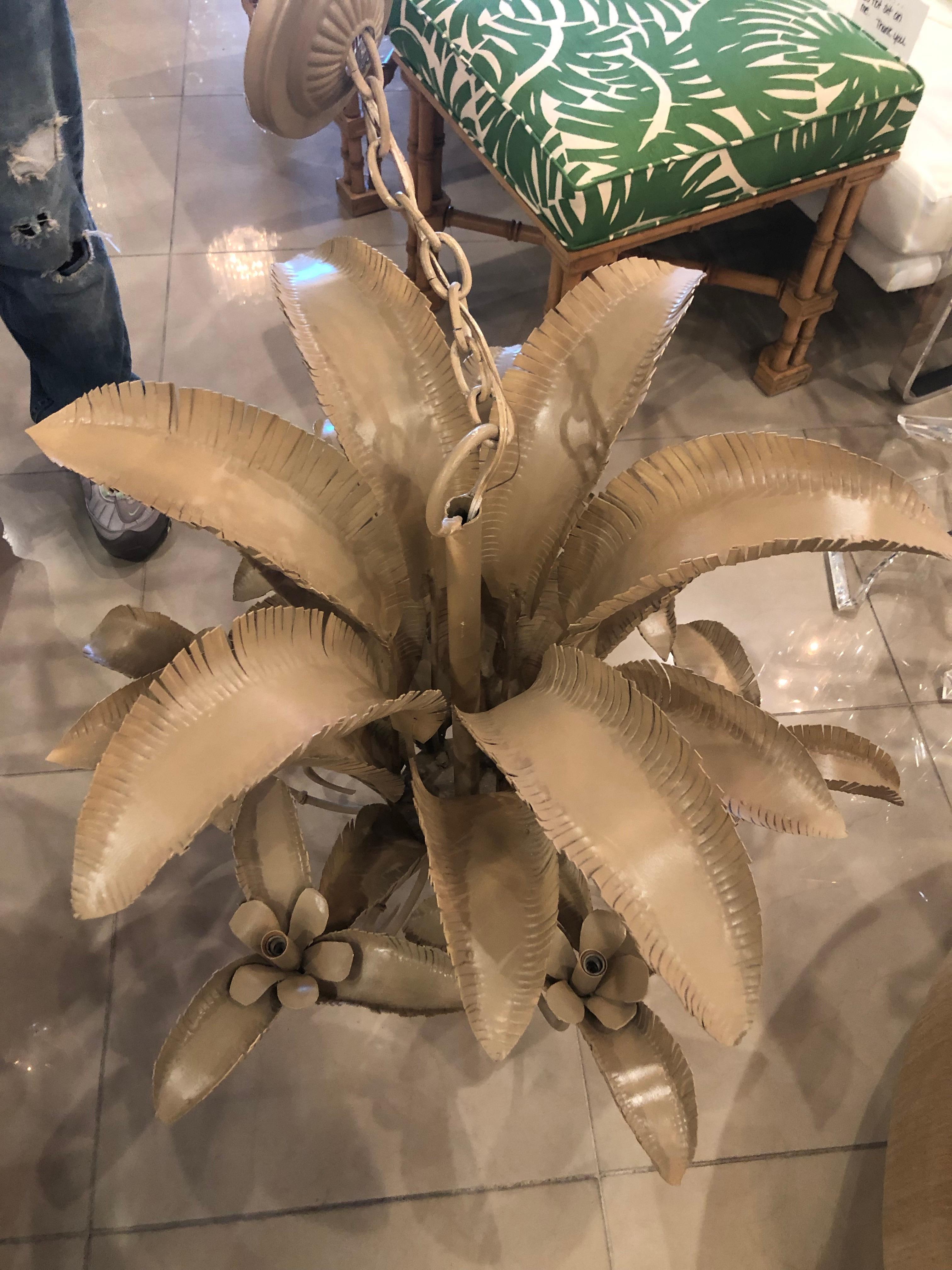One of the most beautiful palm frond leaf chandeliers I have seen! It’s so full of leaves, layer after layer. The arms even have leaves. It’s large and heavy. Holds 6 lights. Comes with original ceiling cap. Color is as found tan.