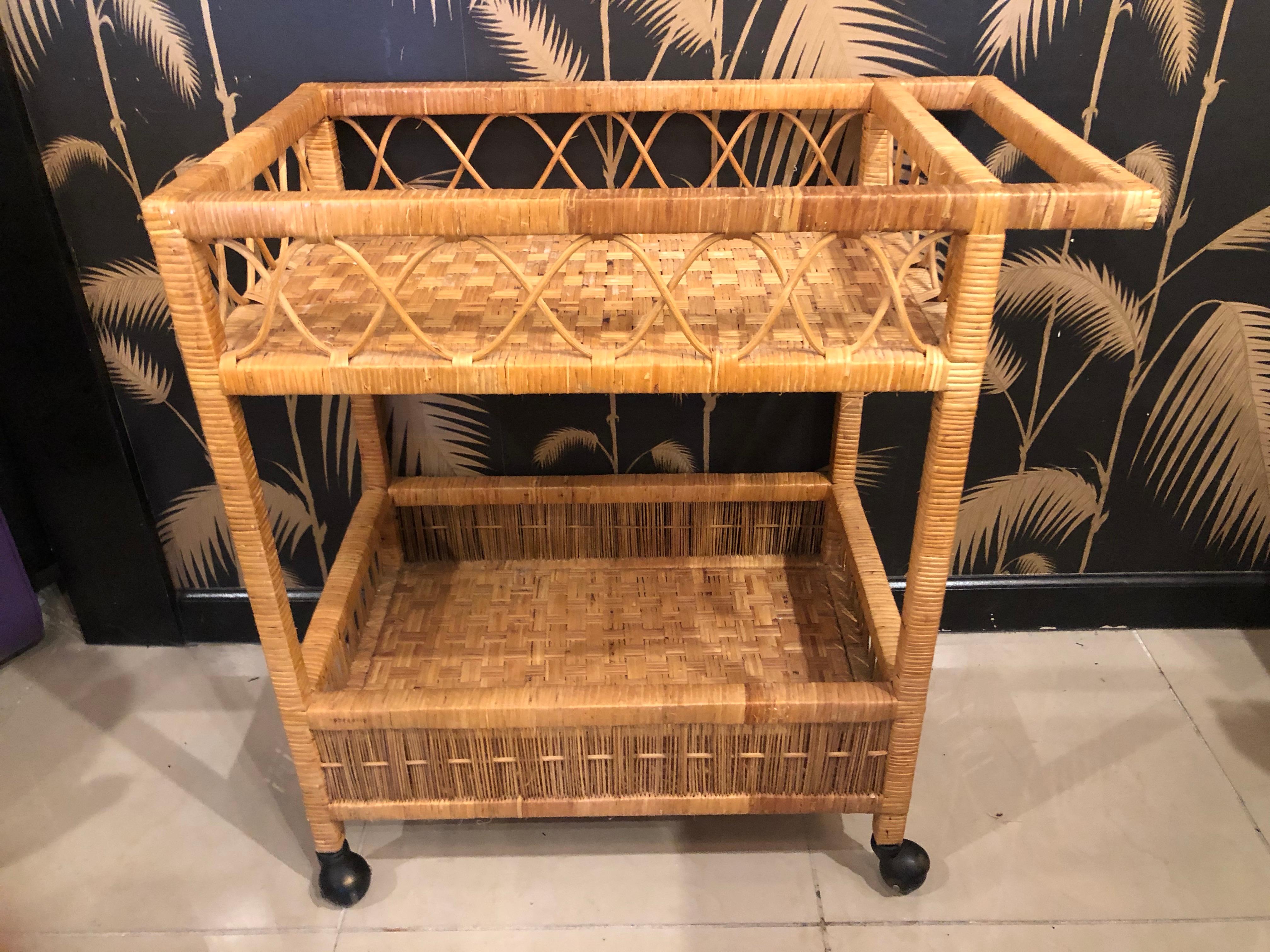 Vintage wicker and rattan bart serving cart. No broken or missing rattan or wicker. Two shelves. Black castors. If needed you can add glass shelves to the shelves. Additional cost will apply.