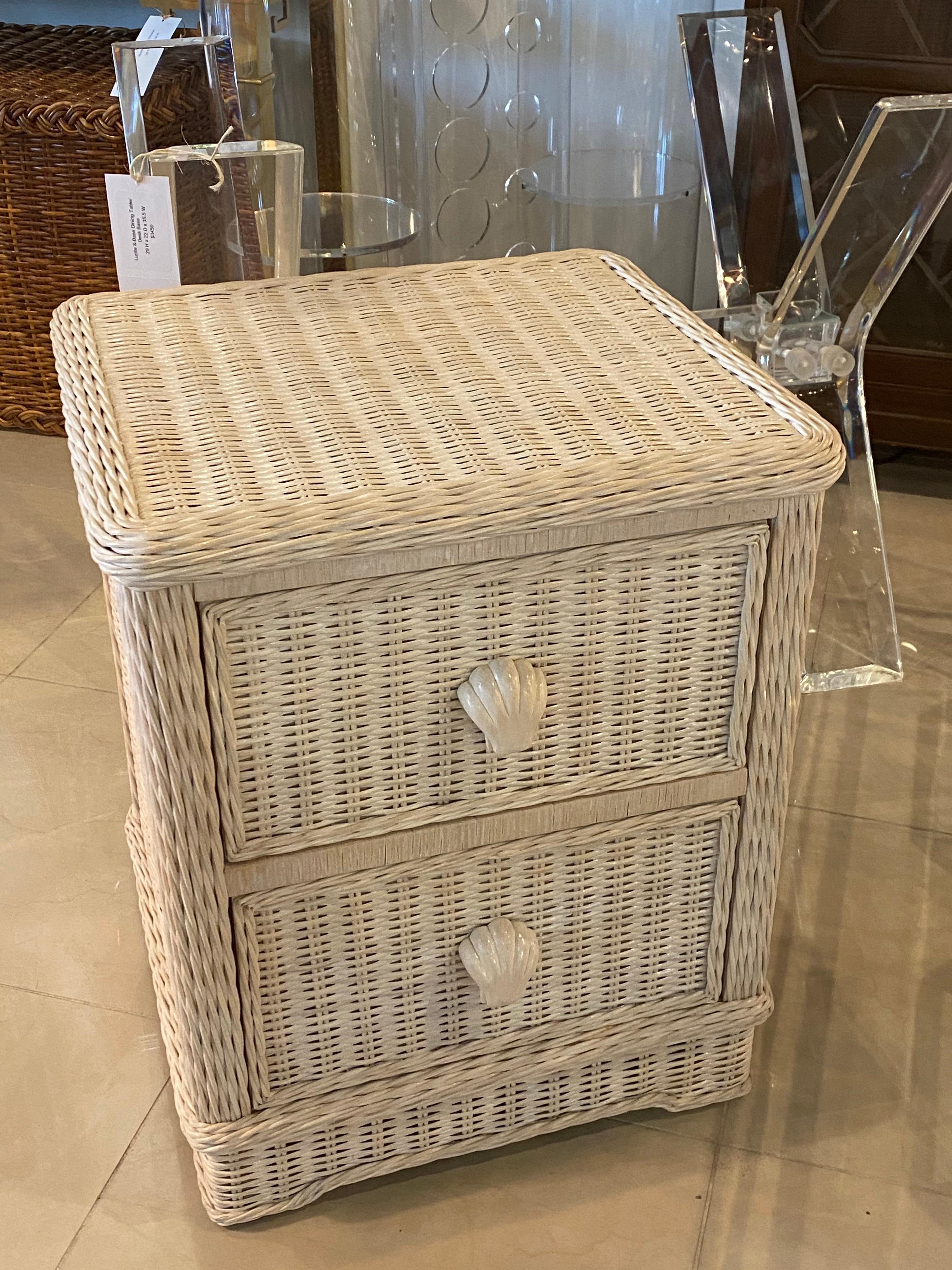 Lovely vintage wicker nightstand with 2 drawers. Original washed cream color. Carved wood shell seashell drawer pulls. No damage to wicker.