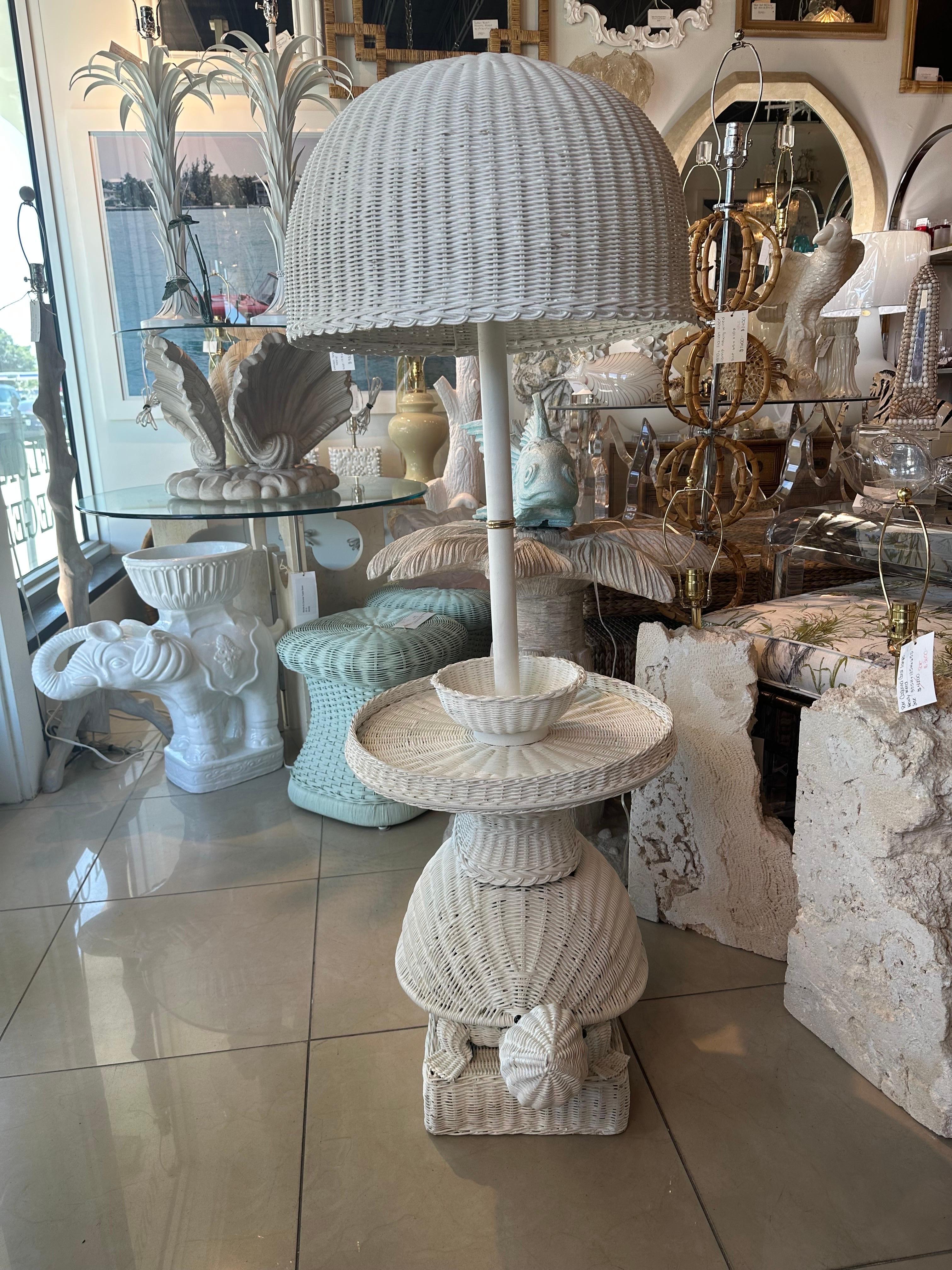 Vintage white wicker turtle floor lamp table. This has been newly wired, 3 way sockets, clear cord, brass hardware. Original white painted finish as found. minor imperfections and choppiness to paint. No damage to wicker. Dimensions: 54 H x 26 D x