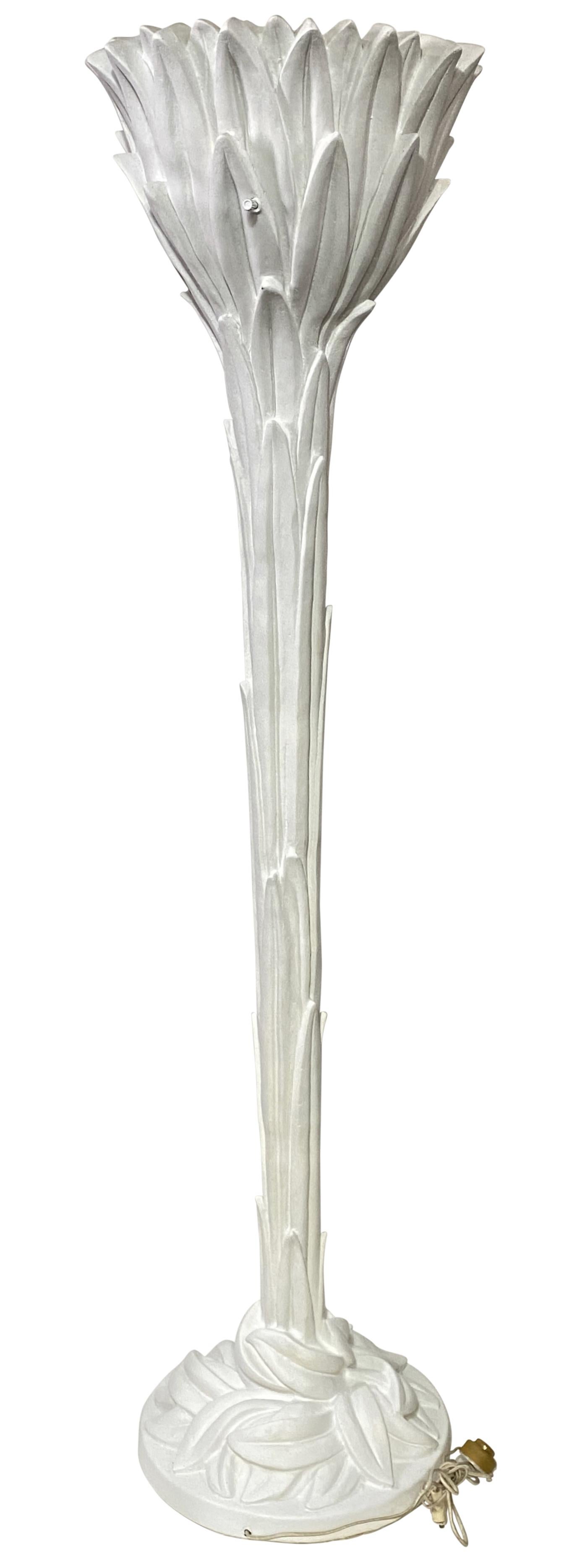 Iconic palm frond torchiere floor lamp after the design by famed French decorator Serge Roche. This tall and regal floor lamp exudes a tropical splendor with a twist of Baroque flare, which originally inspired Serge Roche's work. Heavily constructed