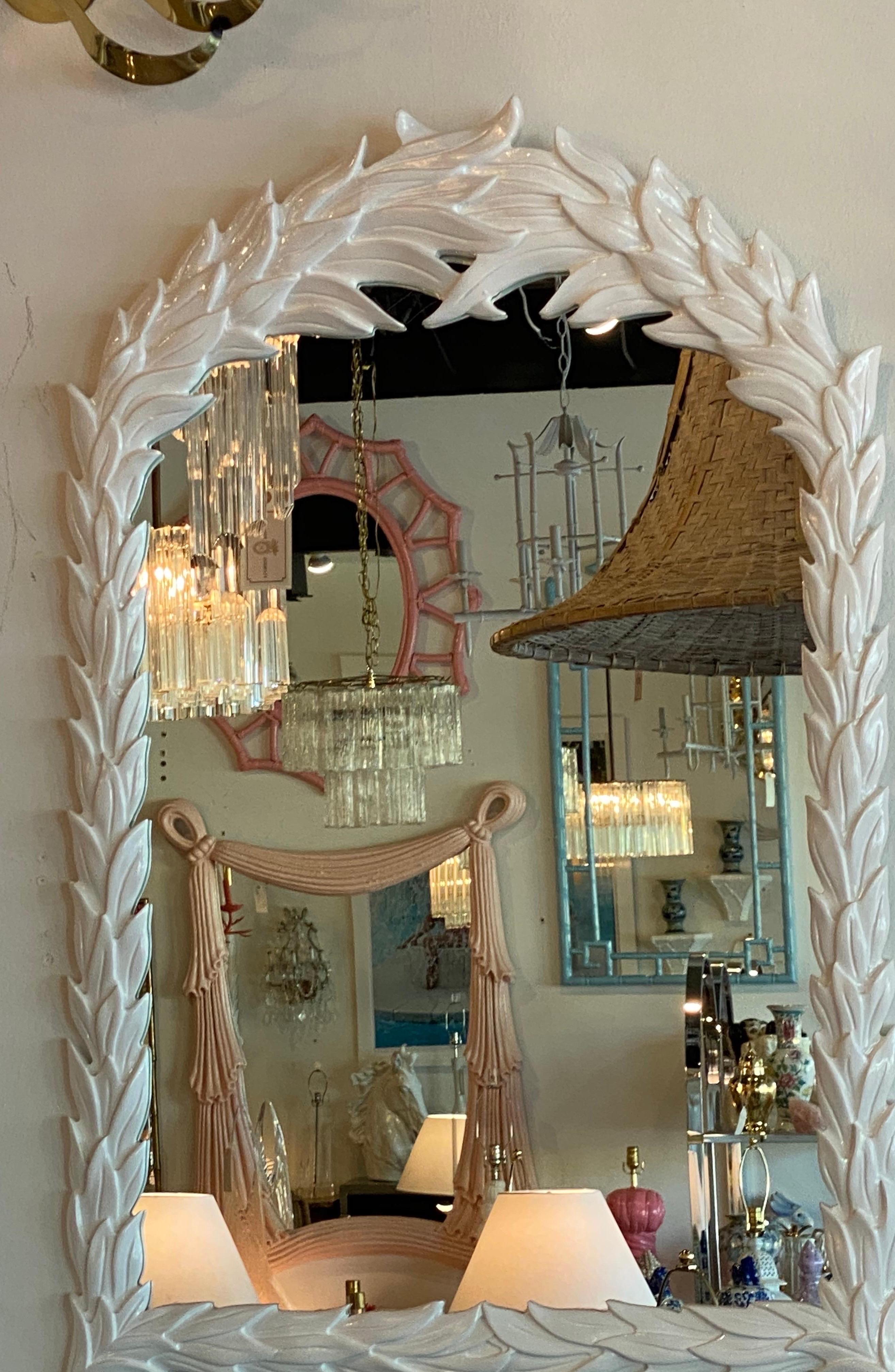 Beautiful vintage palm frond tree leaf wall mirror. This has been professionally lacquered in a white gloss. Original mirror which may have minor wear.
In the manner of Serge Roche.
  