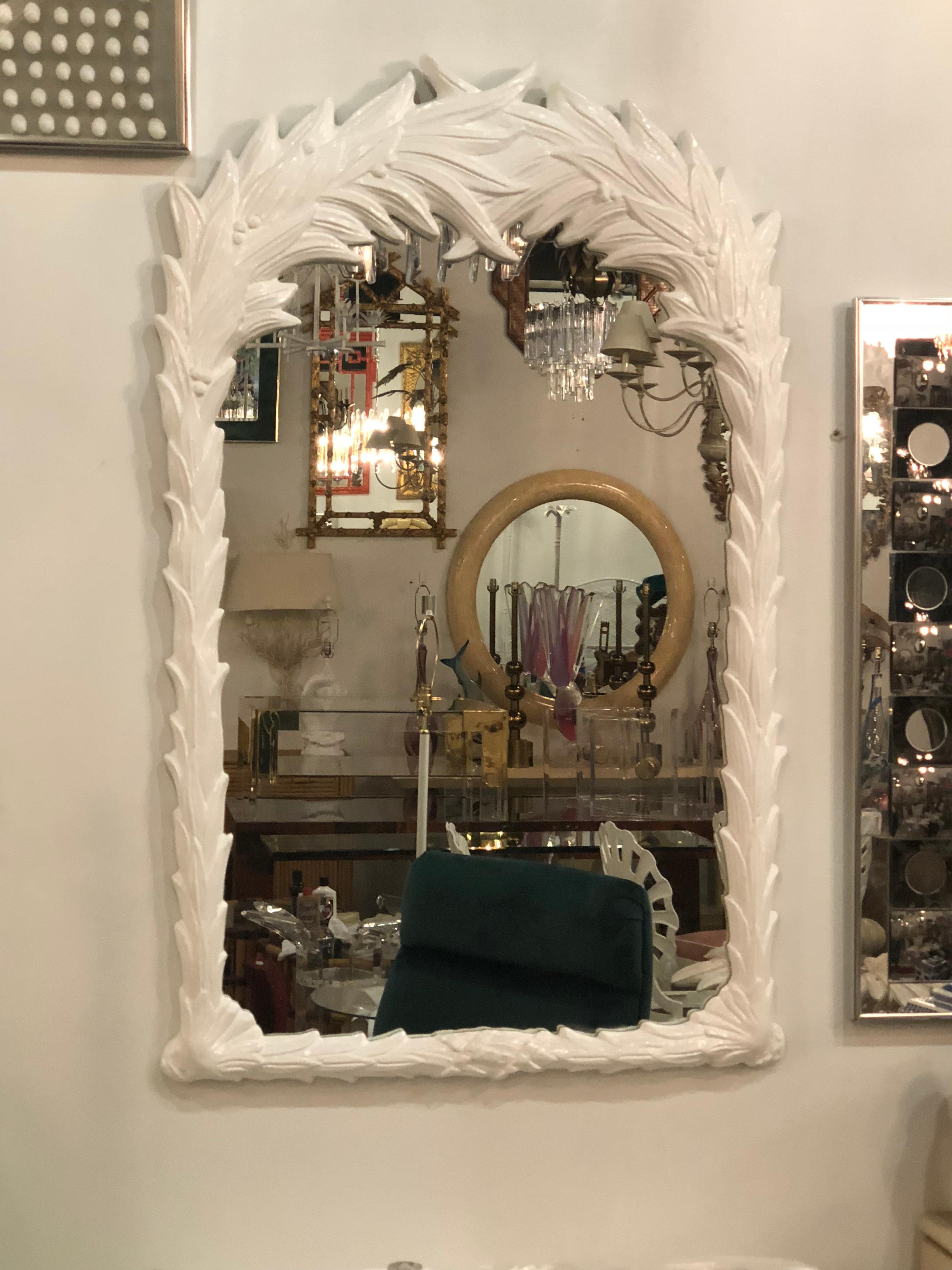 Beautiful vintage palm frond tree leaf wall mirror. This has been professionally lacquered in a white gloss.
In the manner of Serge Roche
New mirror insert.