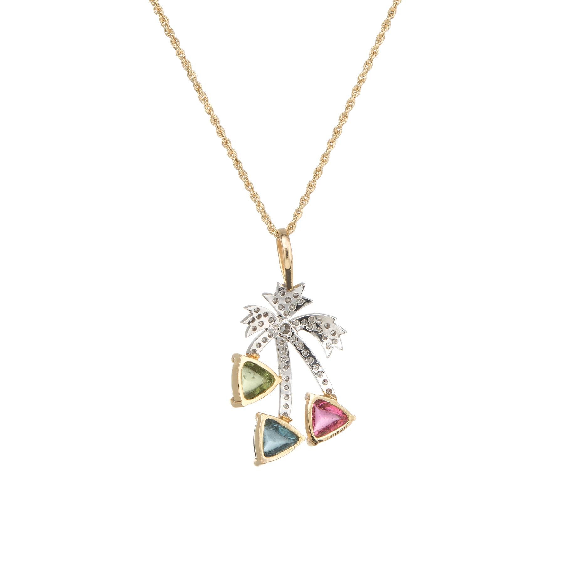 Elegant and finely detailed palm tree necklace, crafted in 14 karat yellow gold.  

Sugarloaf cut pink tourmaline, blue topaz and peridot each measure 7mm (estimated at 1 carat each - 3 carats total estimated weight), accented with an estimated 0.50