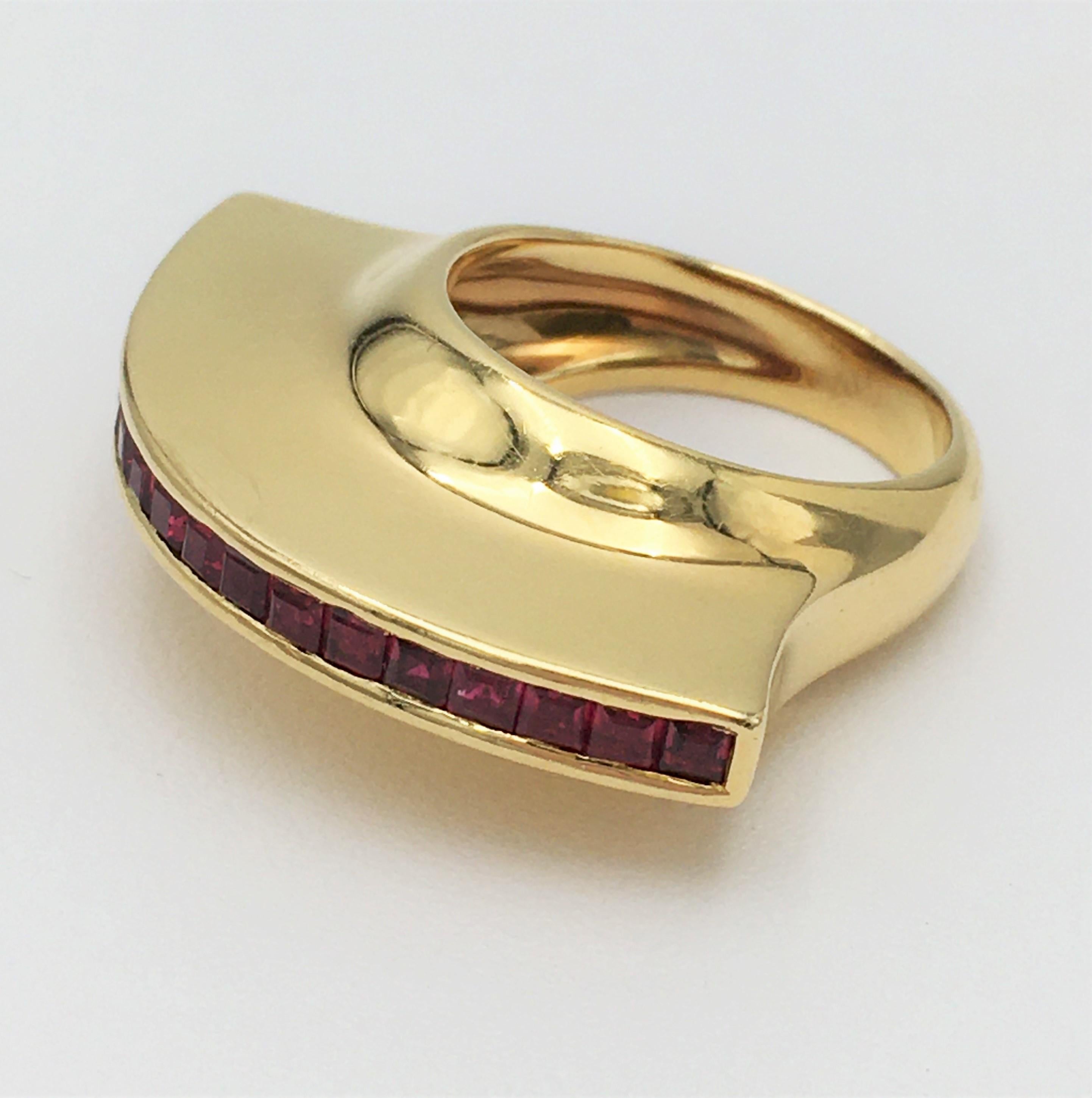 Authentic vintage Paloma Picasso for Tiffany & Co. fan ring crafted in 18 karat yellow gold and set with an estimated carats of calibre cut rubies weighing an estimated 0.95 carats. Signed Tiffany & Co, Paloma Picasso, 18K, 1980. Ring size 6. Not
