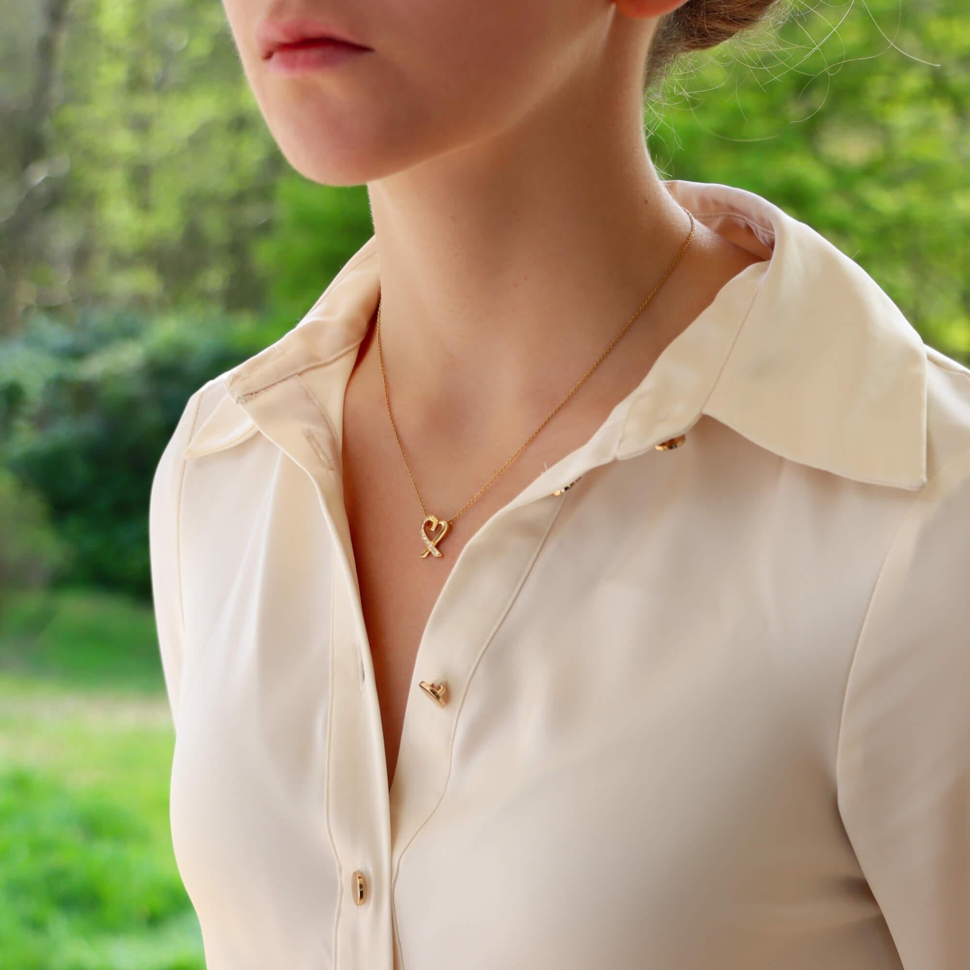 A beautiful vintage Paloma Picasso for Tiffany & Co. ‘Loving Heart’ diamond pendant set in 18k yellow gold.

From the current Paloma Picasso ‘Loving Heart’ collection, the pendant depicts a solid yellow gold open heart, half set with round brilliant