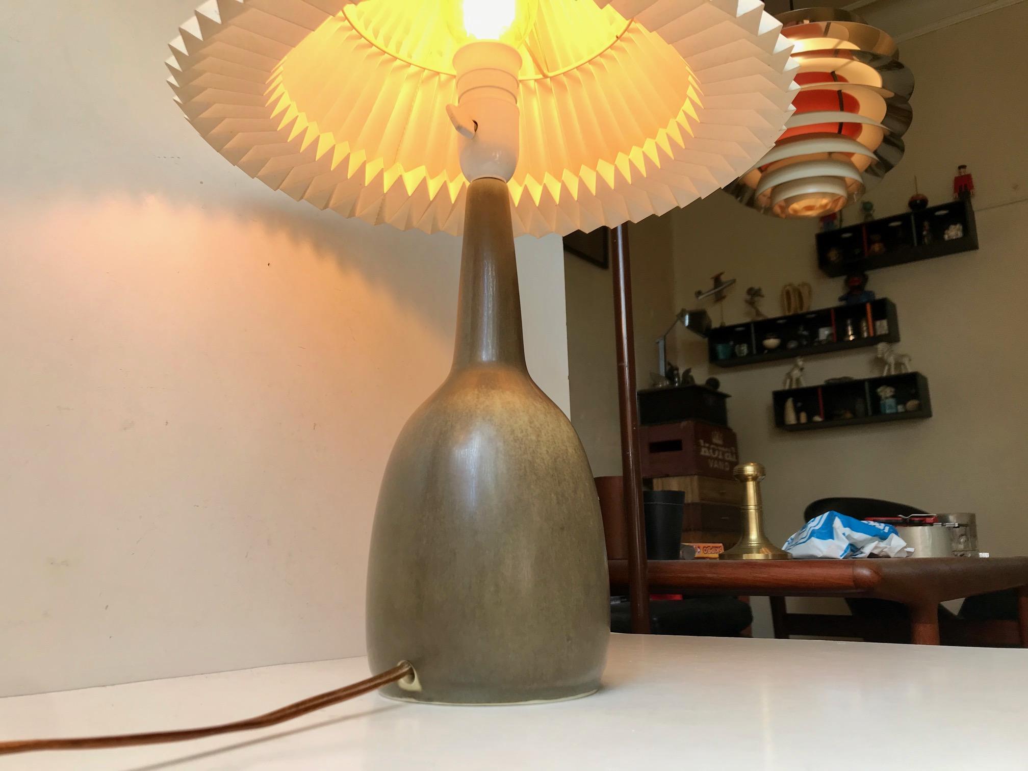 A rare gourd shaped ceramic table light with delicate exposed edges and olive green haresfur glaze. Very similar to designs by Bernt Friberg. This one is special and was made for Hafnia Liv (life insurance). It was designed by Per Linnemann-Schmidt
