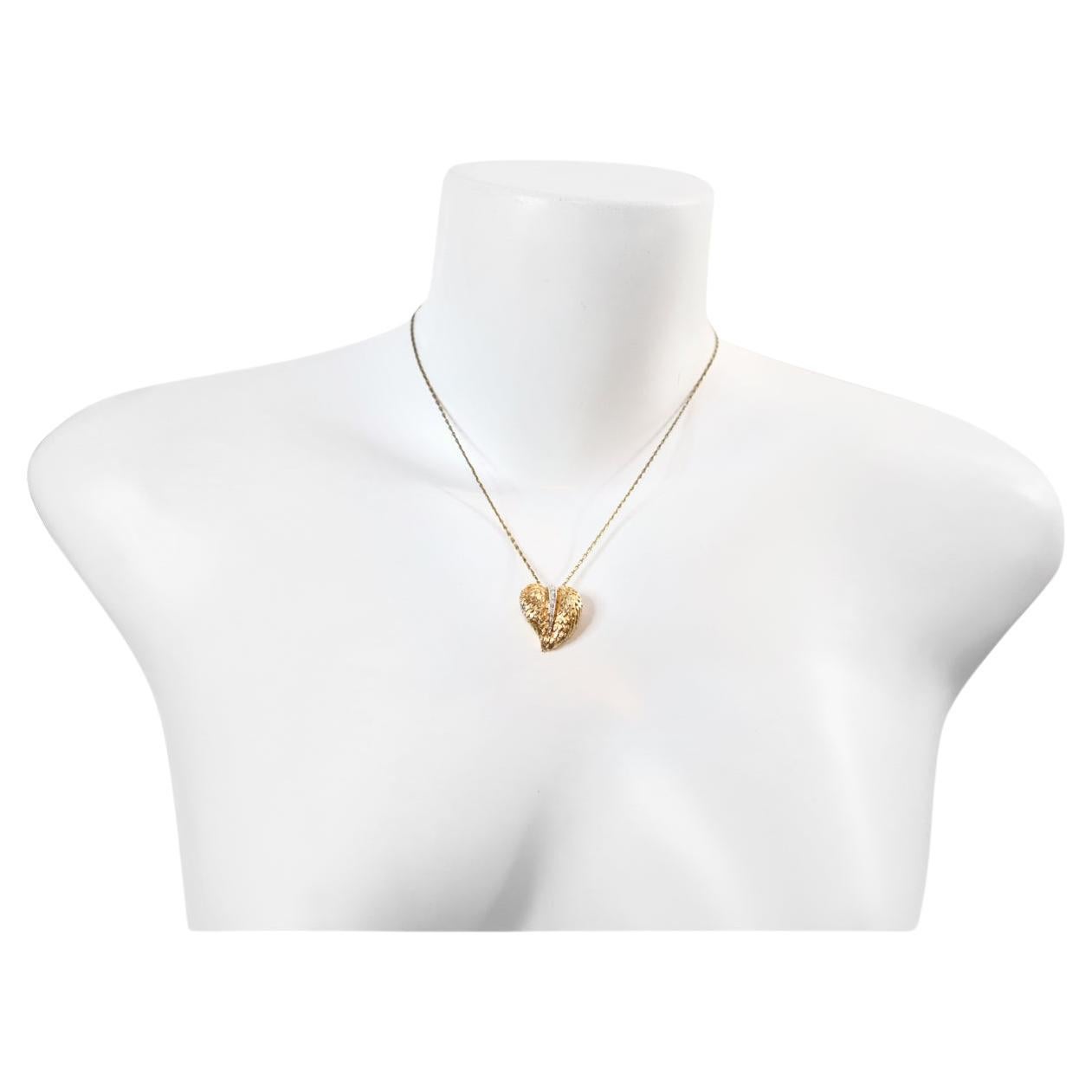 Vintage Panetta Gold Tone Heart Necklace Circa 1960s. This small and delicate heart has the appearance of fine jewelry in its presentation.  They are shown in gold metal with diamante placed on the metal of the heart. They are enough to show but not