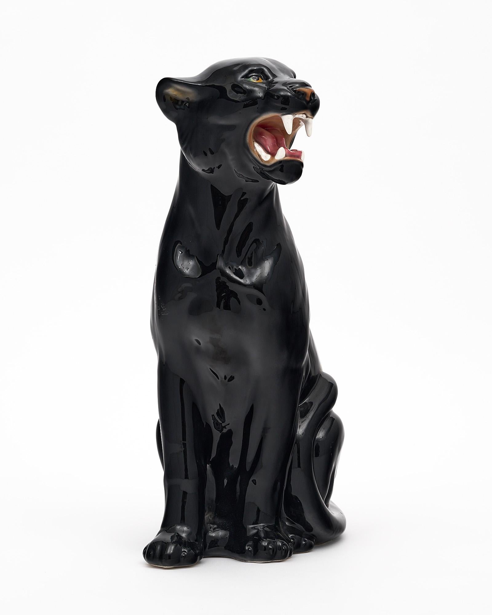 Italian vintage panther sculpture in polychrome ceramic with beautiful emerald colored eyes. The life-like pose and expression are captivating.