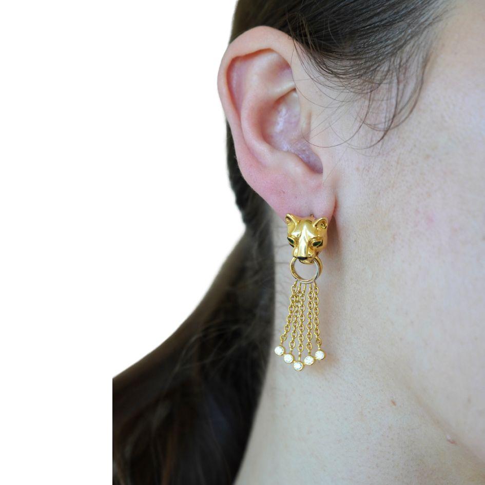 These Cartier Panthère earrings are a striking example of the house’s most iconic motif. Crafted in 18k yellow gold, the earrings each feature a sculpted panther head with vivid emerald eyes and a polished onyx nose, capturing the fierce yet elegant