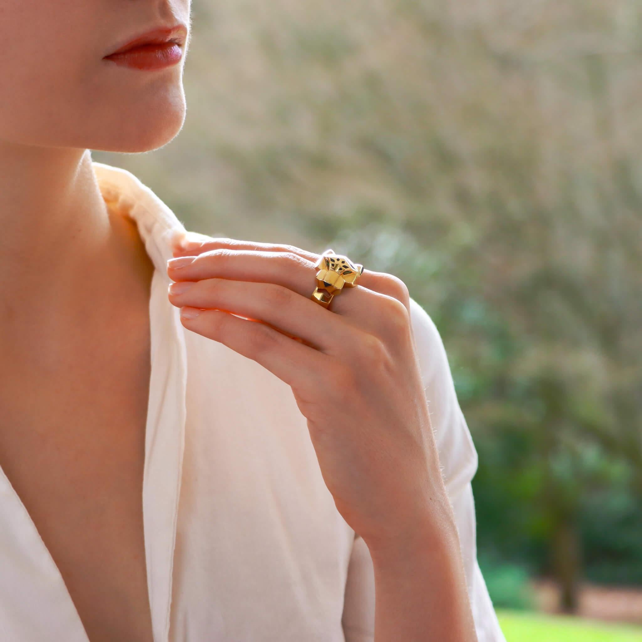  A beautiful vintage Panthère de Cartier ring set in solid 18k yellow gold. 

This striking piece depicts Cartier's most iconic motif, the panther. The panther is made of 18k yellow gold and set with tsavorite eyes and an onyx nose. To the head of