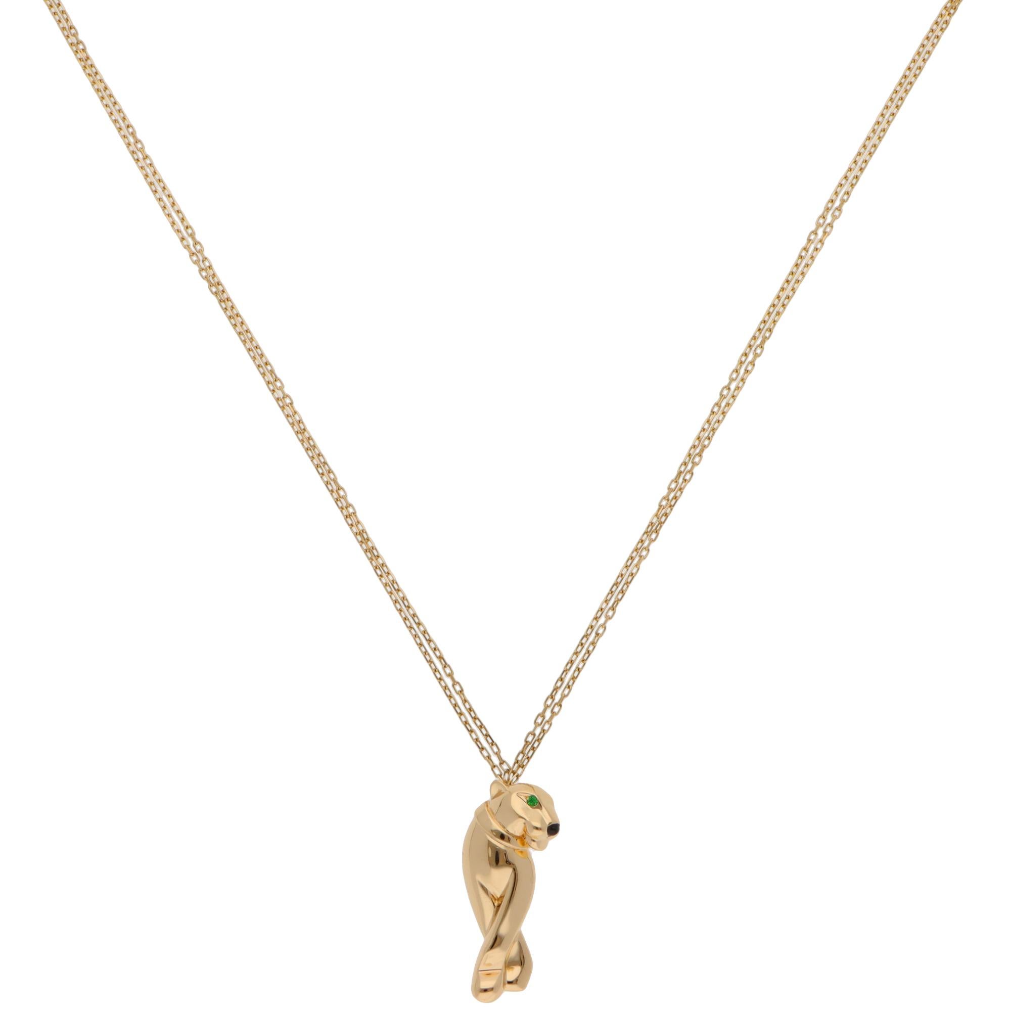 An iconic vintage Panthère de Cartier tsavorite garnet and onyx pendant necklace set in 18k yellow gold.

This piece features Cartier’s iconic panther motif, crafted from solid 18k yellow gold. The panther is adorned with two faceted tsavorite