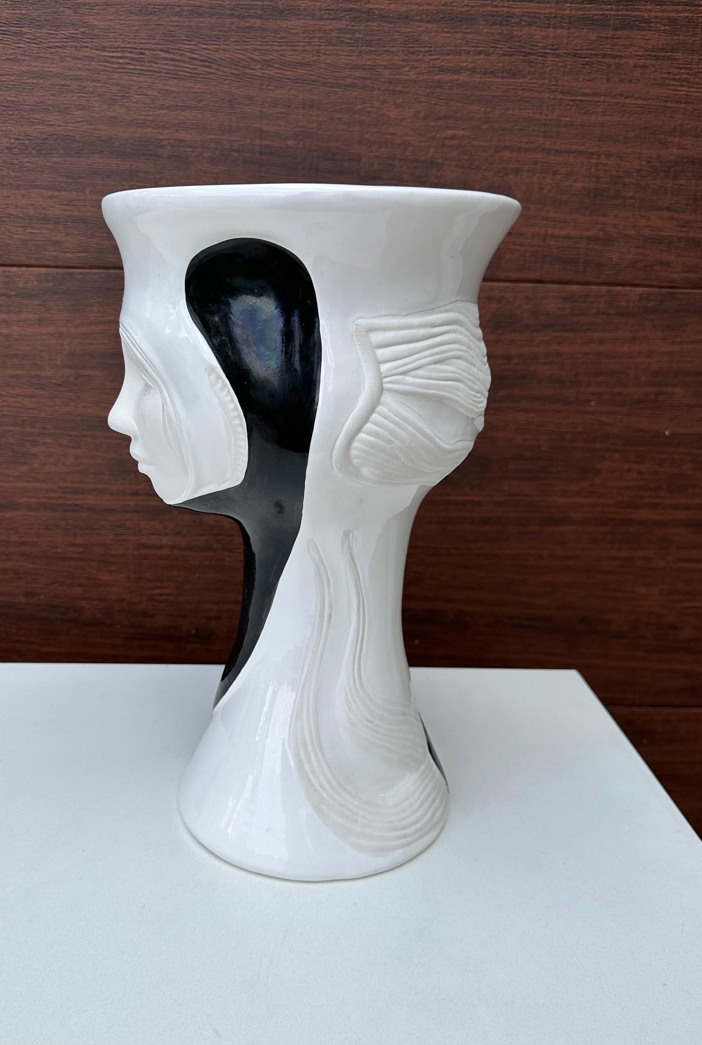 This Paolo Marioni sculptural face vase is a unique addition to any collection. Made in Italy during the post-modern era, this vase showcases intricate details that make it a true work of art. Its design is inspired by human faces and features,