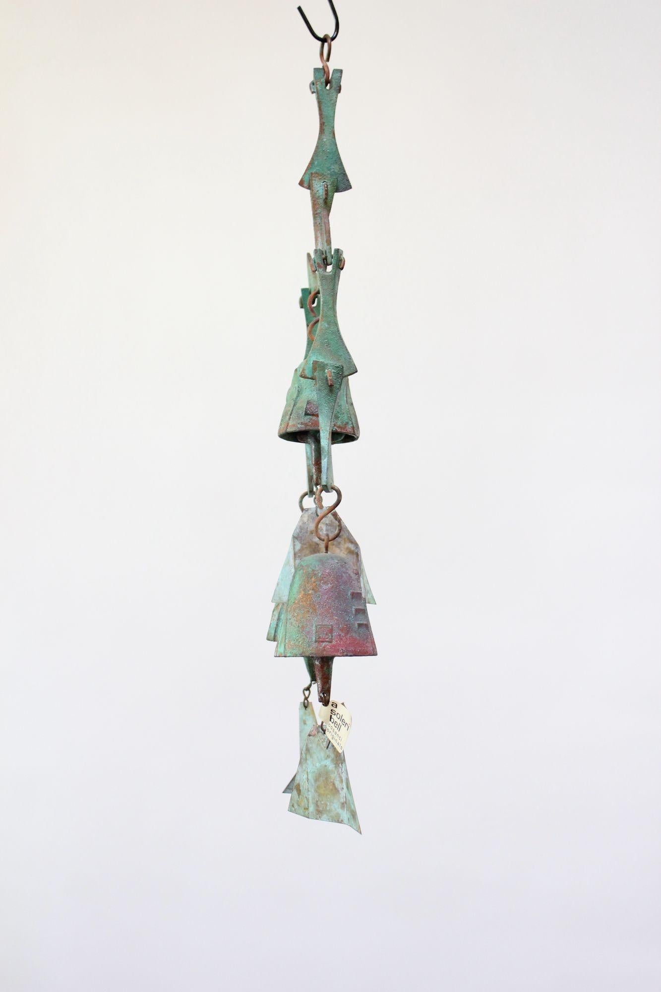 Three bell/fin wind chime designed by architect, Paolo Soleri for Cosanti Originals (1970s, Arizona, USA).
Bronze cast elements with verdigris patina and multi-color pigment throughout.
Unique, given its early production and the colors