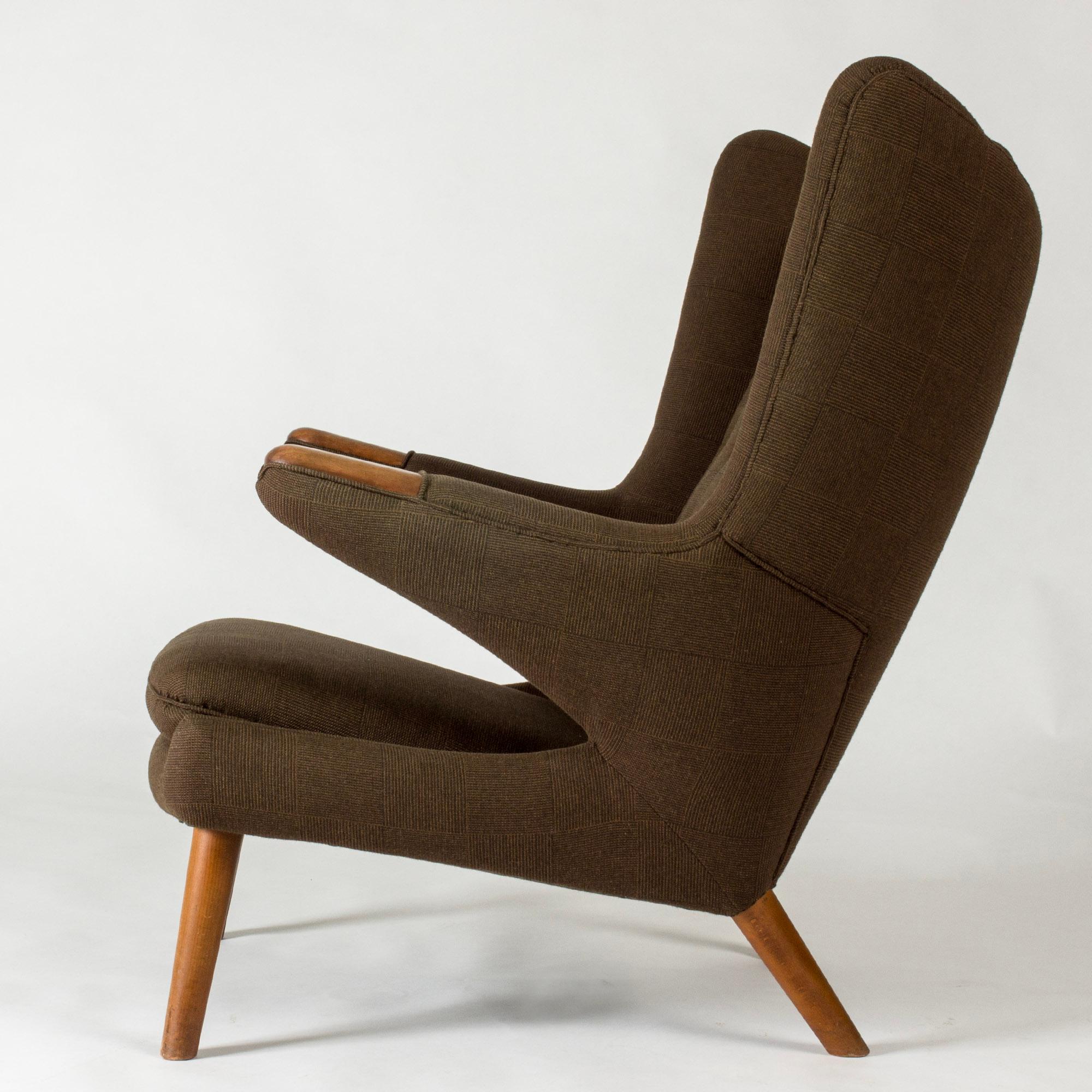 Iconic “Papa Bear” lounge chair by Hans J. Wegner, in a wide, comfortable design upholstered in brown wool fabric. Handles with oak details at the ends.