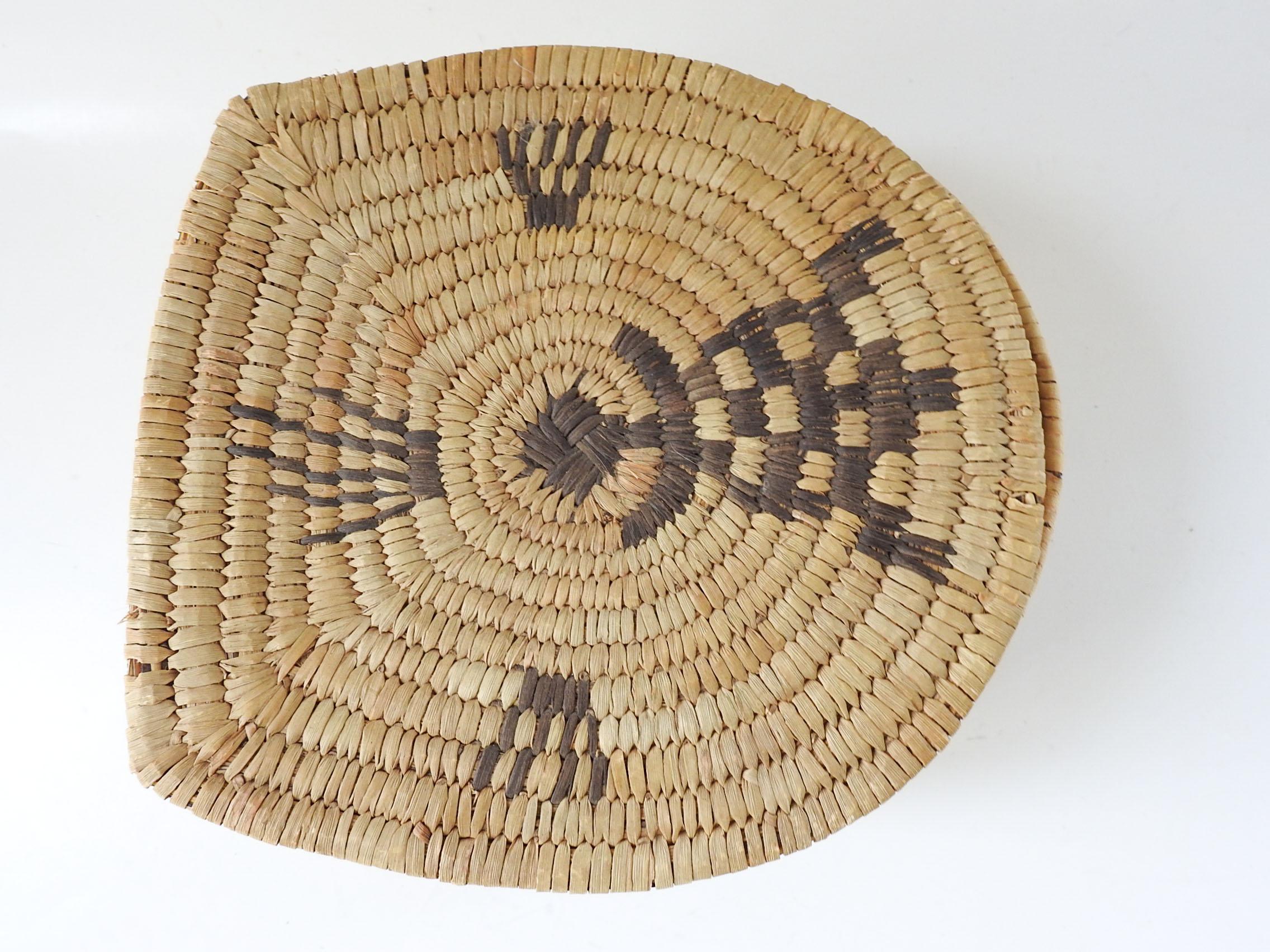 Vintage lidded handwoven Papago Indian basket with turtle motif.  Original hinges are missing, minor fading.