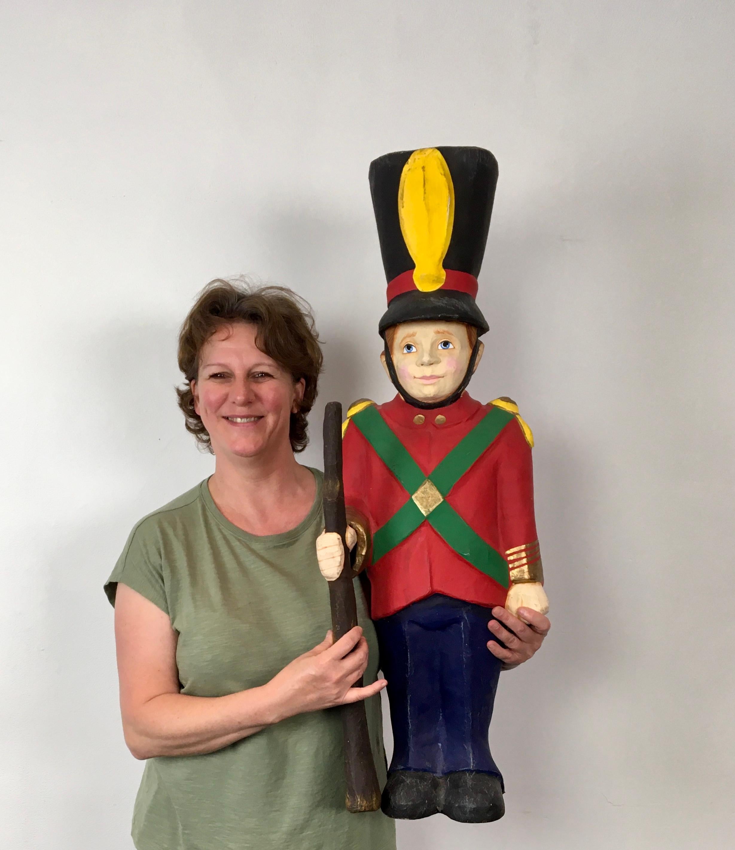 Vintage paper mache Royal guard doll.
This Royal guardian soldier has a beautiful uniform or costume: blue pants, red coat with green stripes and yellow shoulder pads, golden accents and large black hat with yellow logo. This cavalry soldier is