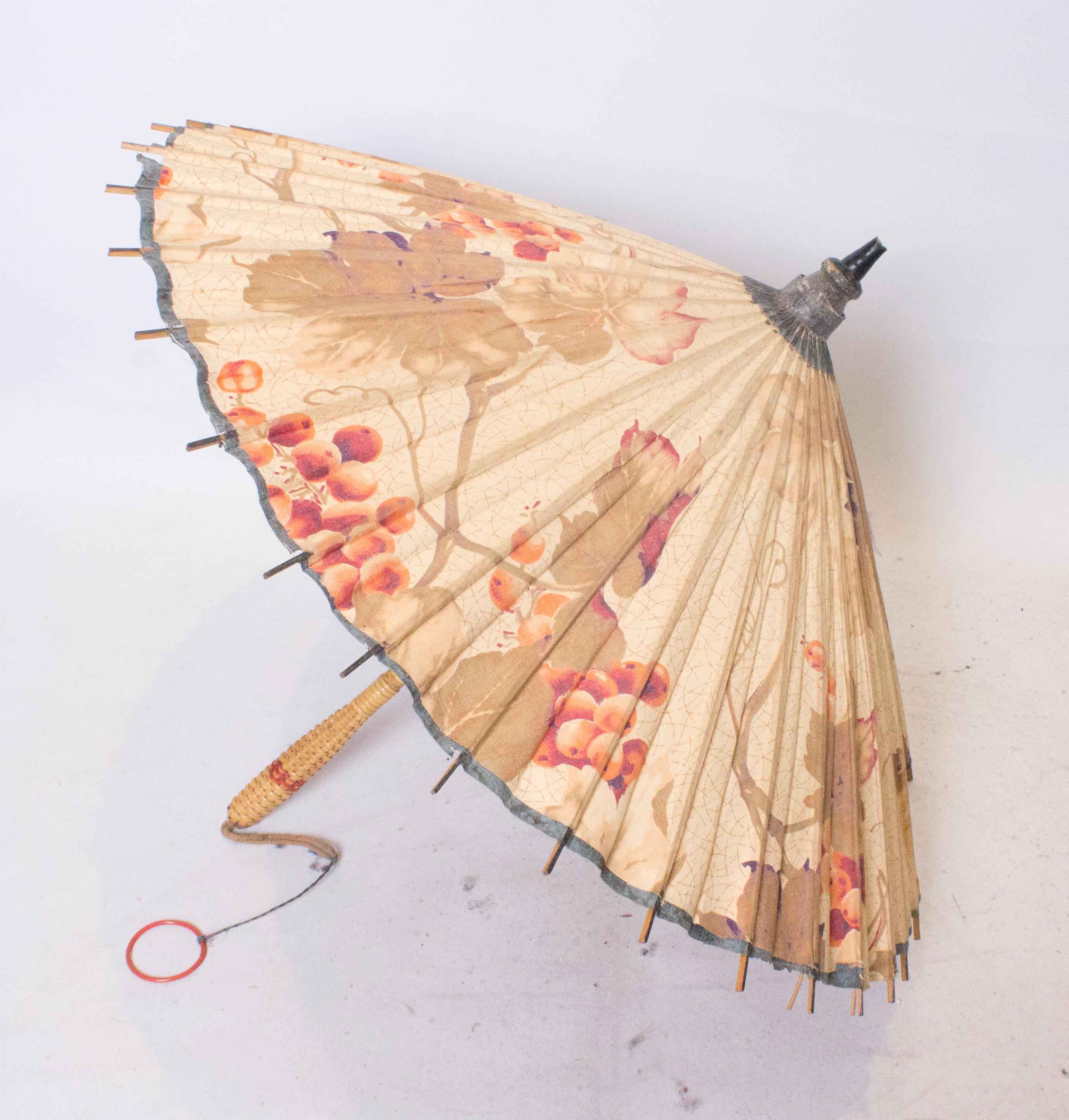 A pretty vintage parasol with a wooden handle. The parasol has a pretty floral print on the inside and outside. 