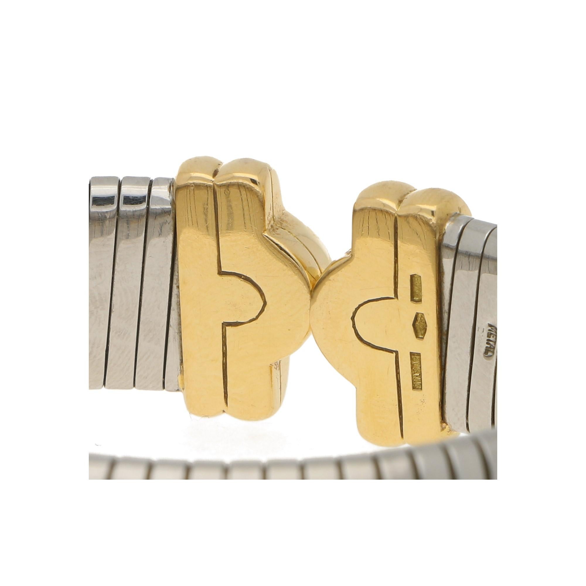 A vintage Bvlgari Tubogas bangle bracelet in 18-karat yellow gold and stainless steel. From the brand's Parentesi collection, the bracelet is designed as a springy flat snake-link stainless steel bangle with Tubogas inspiration, leading to solid