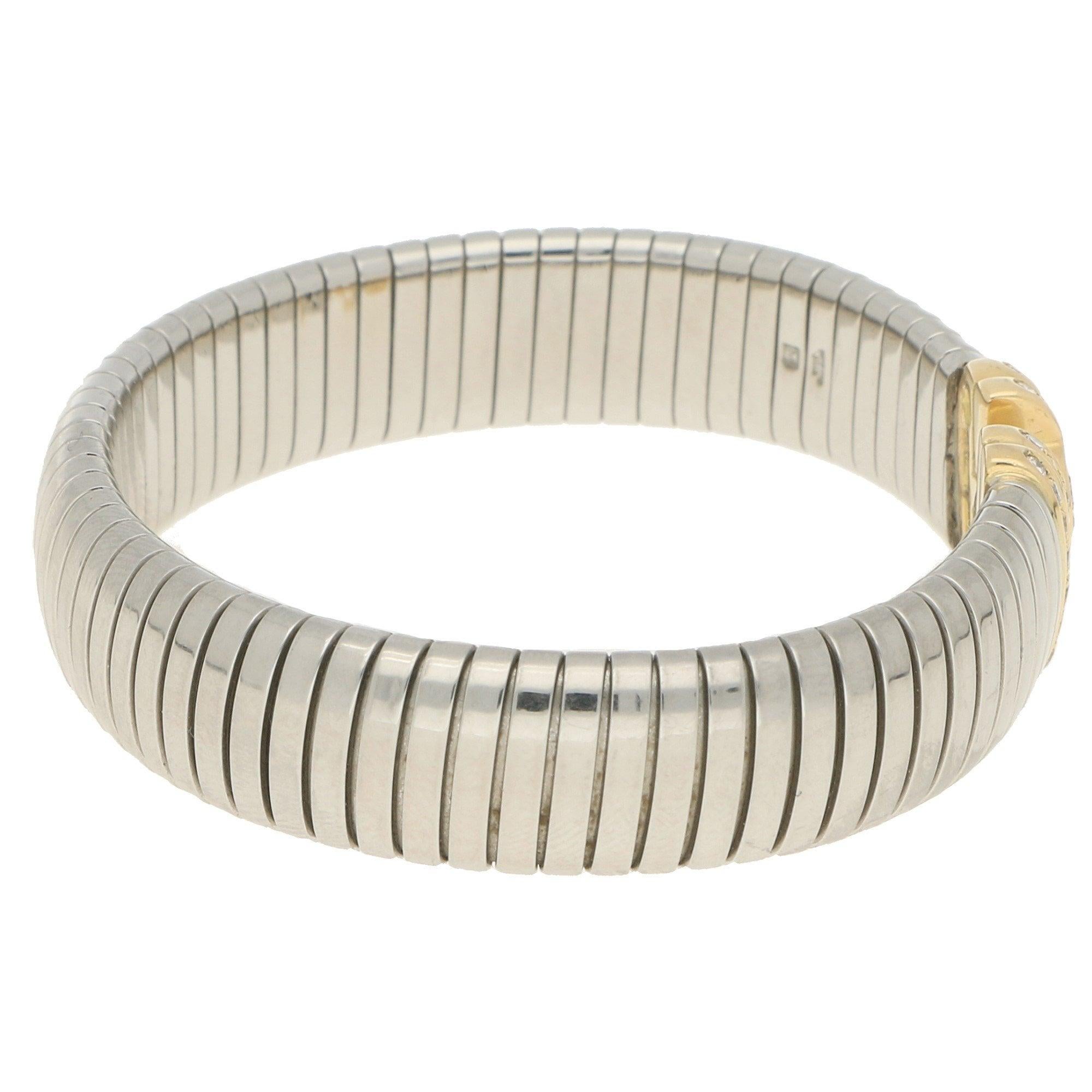 A vintage Bvlgari Parentesi diamond bangle bracelet in 18-karat yellow gold and stainless steel. From the brand's Parentesi collection, the bracelet is designed as a springy flat snake-link stainless steel bangle with Tubogas inspiration, leading to