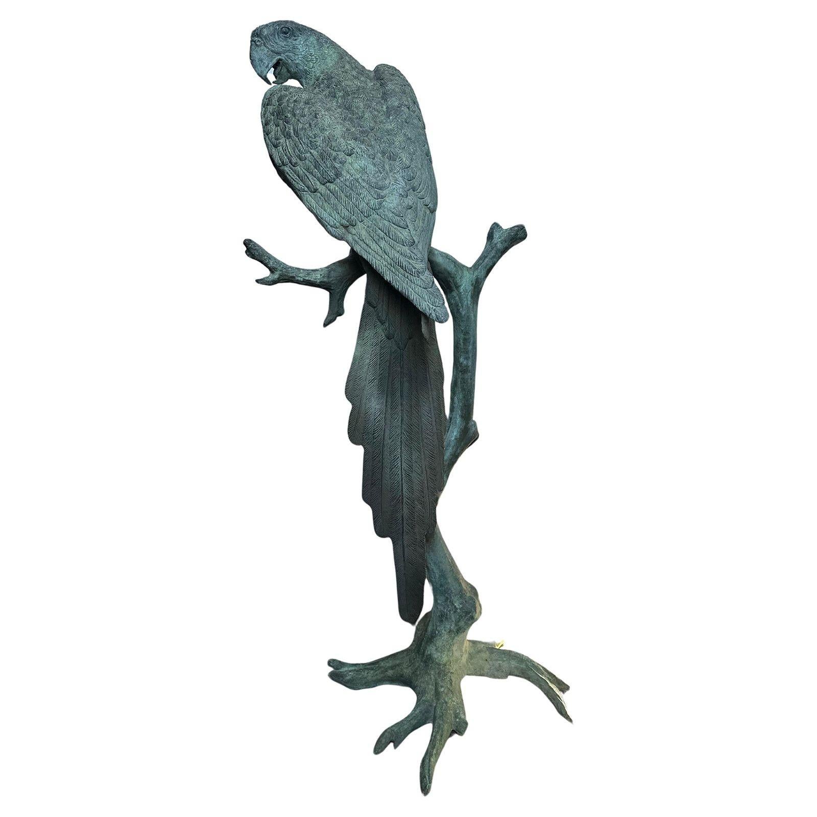 Vintage oversized bronze sculpture of a parrot with green bronze patina after J. Moigniez. This sculpture is meticulously decorated with detail giving it a realistic feel besides its life-size. The piece includes a signature on the root as the