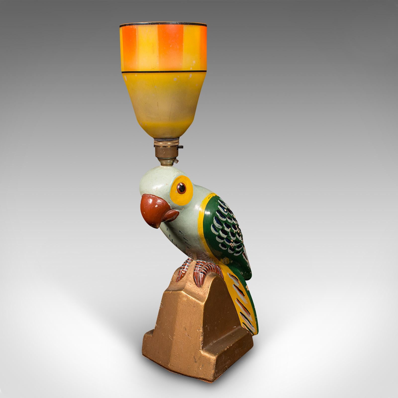 This is a vintage parrot lamp. A French, plaster table or desk light, dating to the late Art Deco period, circa 1950.

Delightful colour with a Brazilian midcentury influence
Displays a desirable aged patina and in good order
Substantial plaster