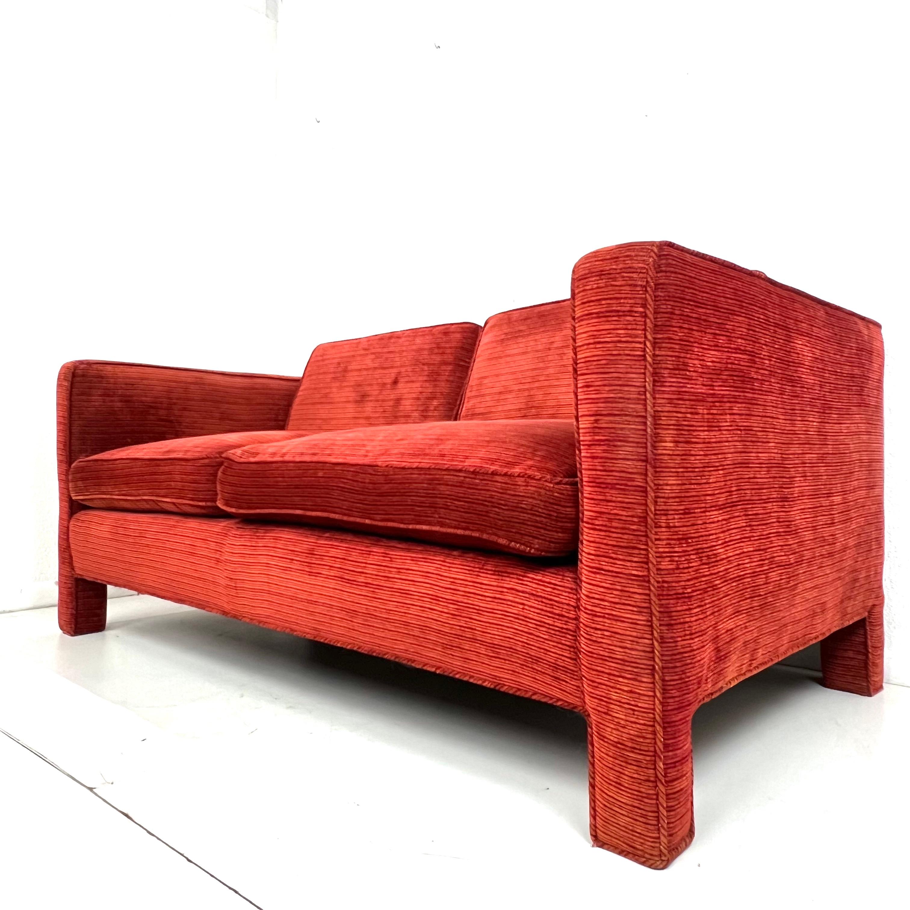 Vintage low profile Parsons style / tuxedo loveseat in the manner of Milo Baughman. The sofa features a straight back, 2 seat cushions and 2 loose back cushions, and fully upholstered frame and feet. Sturdy and in good structural condition; Original