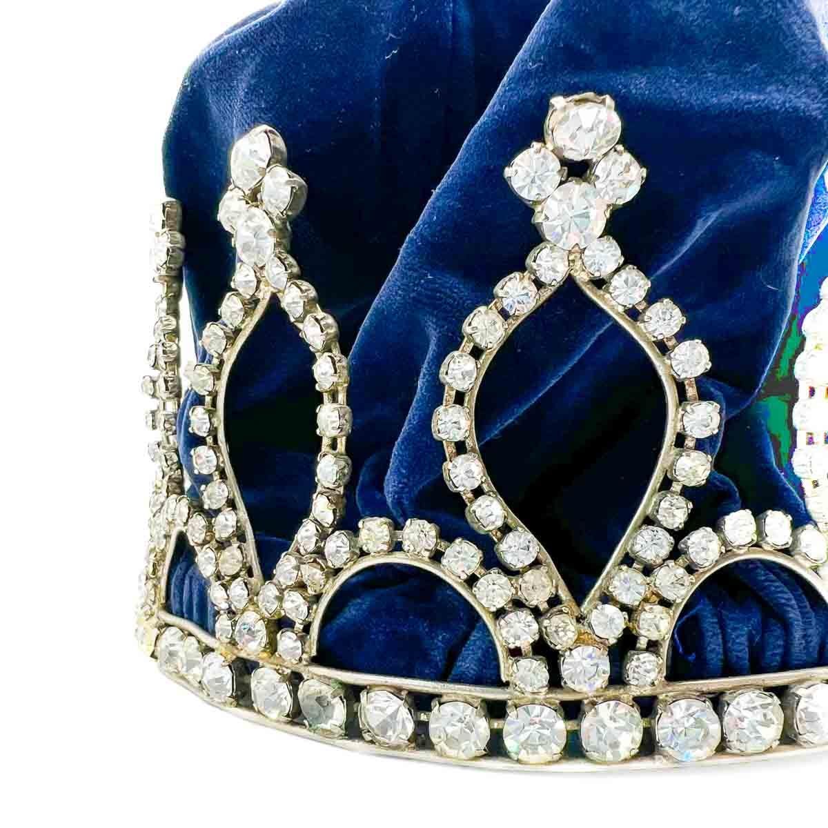 A Vintage Paste Crown most likely dating to the mid century and possibly earlier. A rare find. Hand set with rhinestones the crown can be worn with or without the velvet lining. Reminds us of Royal Crowns or even the Mardi Gras crowns. A truly