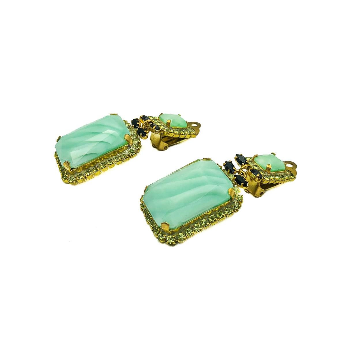 Delightful vintage Green Drop Earrings. Featuring large pastel green art glass stones surrounded by lime green crystal galleries and finished with marquise black crystal accents. All stones are claw set. Good vintage condition, approx. 5cms.