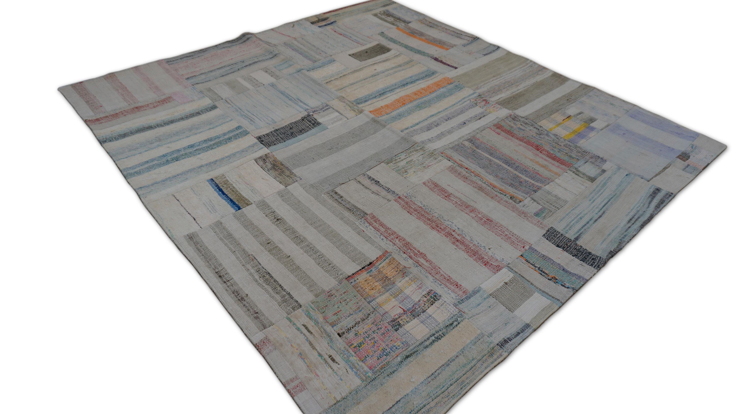 This patchwork rug features a captivating mosaic of vintage fragments, harmoniously stitched together to form a soft yet vibrant contemporary statement. The piece presents a subtle celebration of color and craftsmanship—pastel shades of sky blue,
