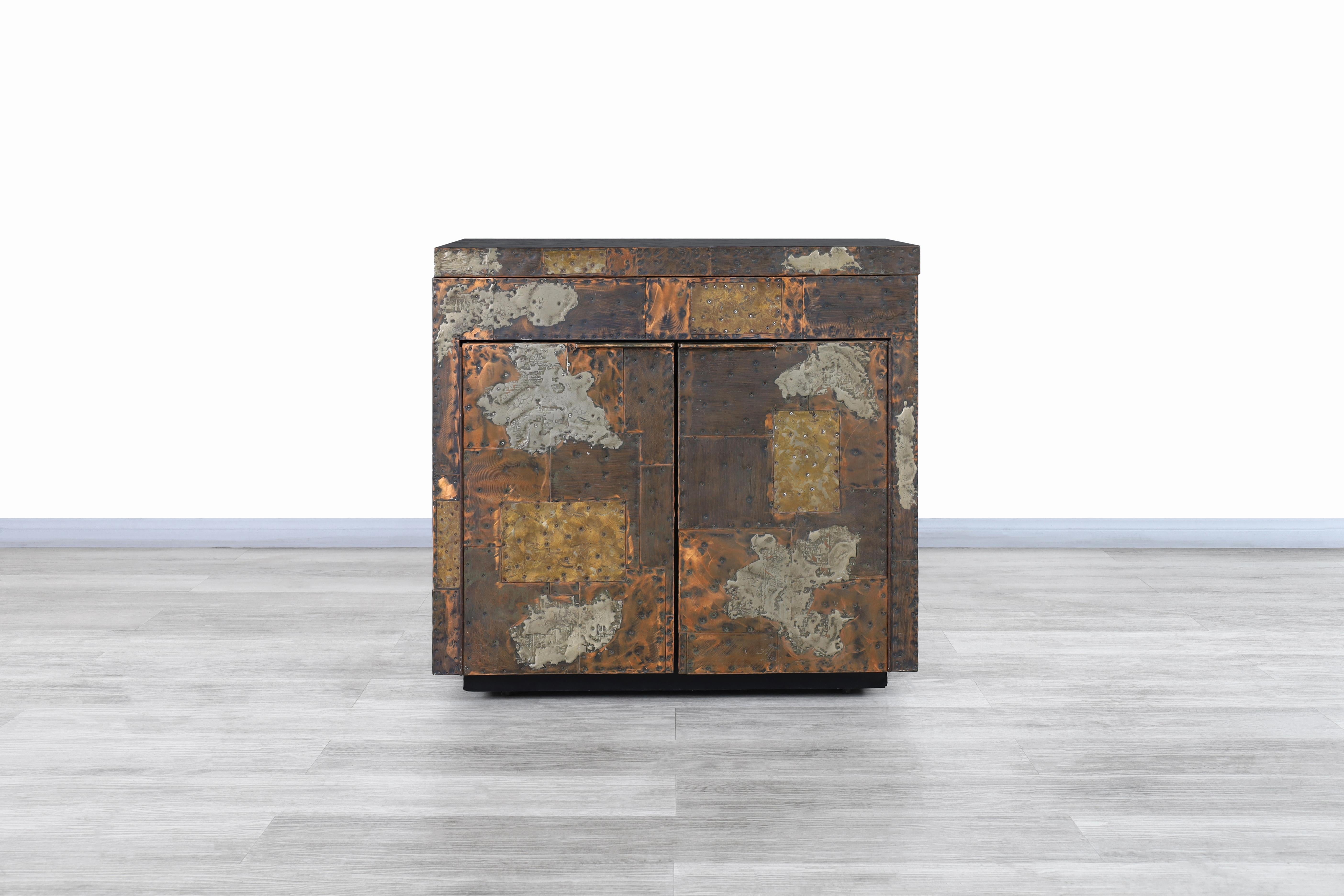 Stunning vintage patchwork fliptop bar cabinet designed by iconic designer Paul Evans for Directional in the United States, circa 1970s. This elegant piece looks more like a graceful sculpture due to its Minimalist design and superior metal