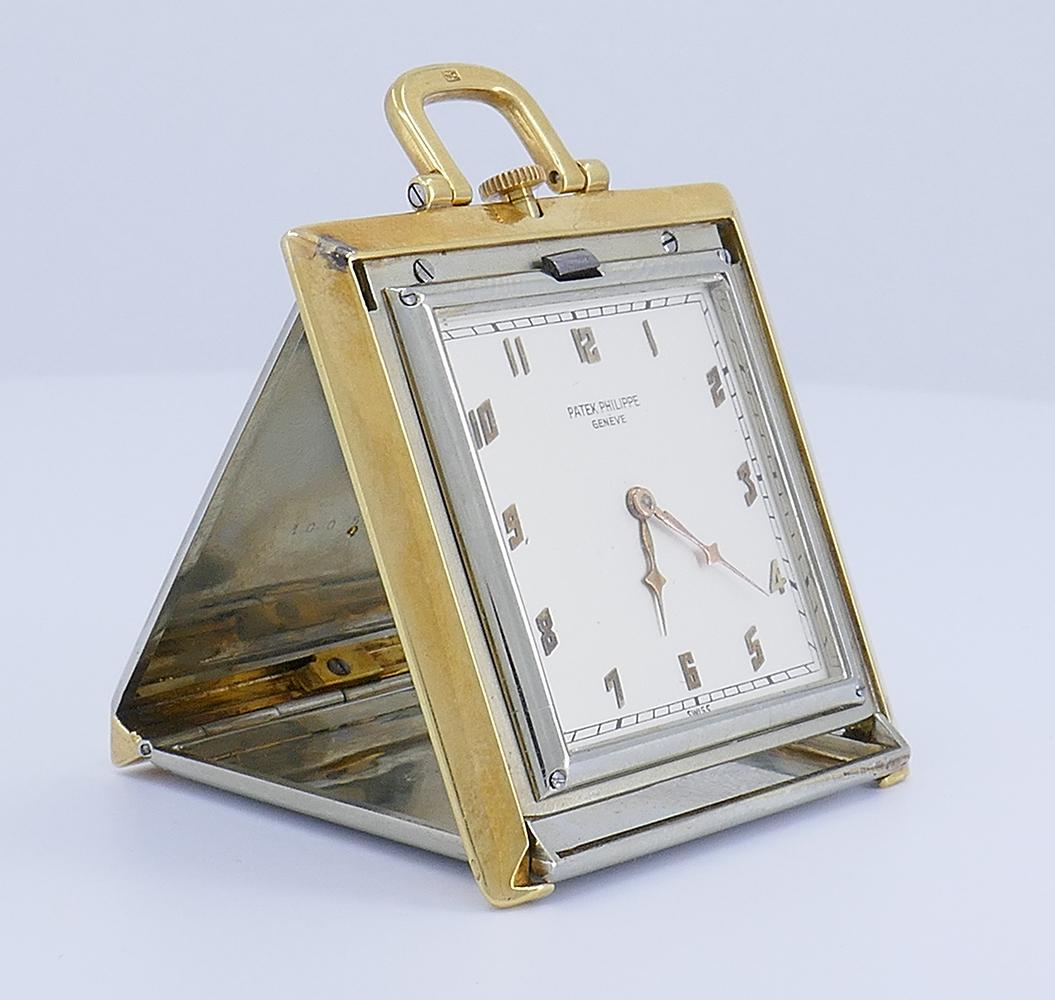 A rare Patek Philippe 14k gold travel clock pendant pocket watch.
The watch is circa 1920s and carries the distinct Art Deco features. 
The square shape face is assembled from the 14k white gold with the frame made of 14k yellow gold. The white gold