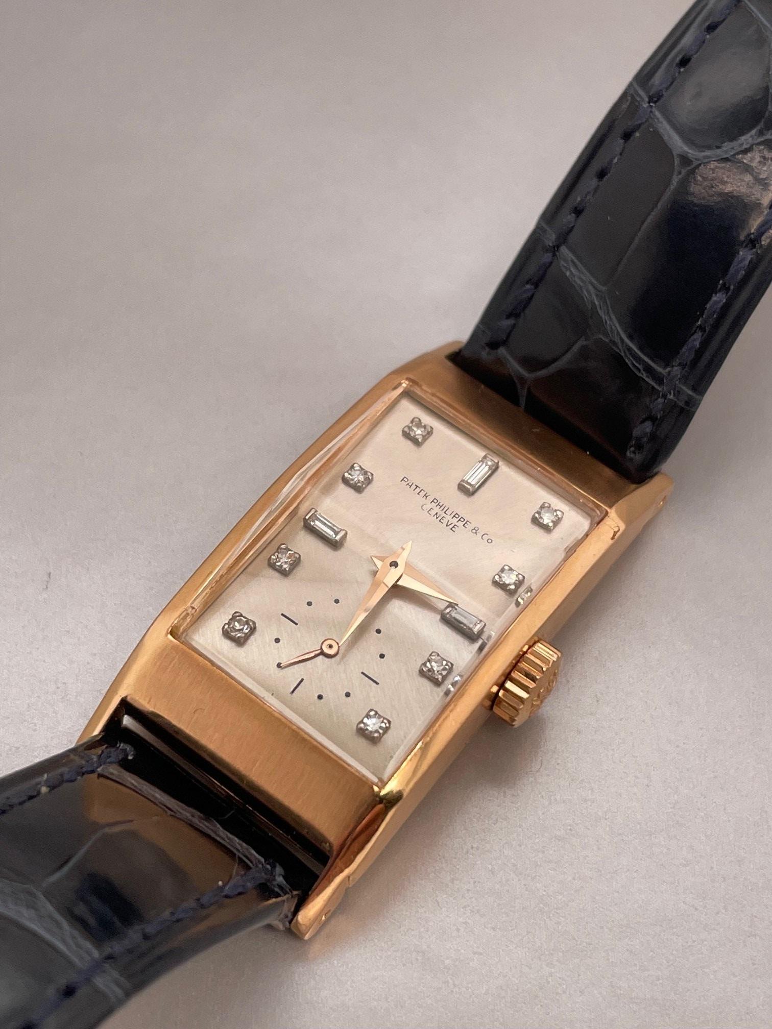 Vintage 18k Rose Gold Patek Philippe rectangular watch featuring a silver dial with diamond hour markers, raised enamel print, original faceted crystal, Patek crown, Watch reference number #2461,  9-90 movement, s#843xxxx, case serial number