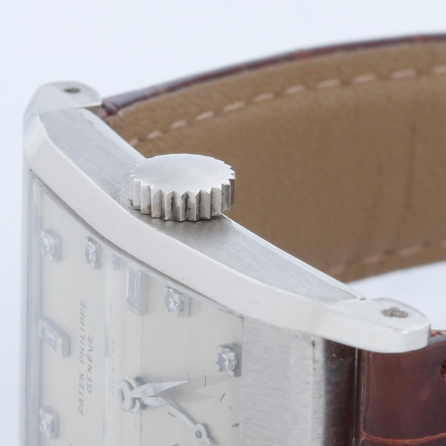 Vintage Patek Philippe & Co. Platinum Watch Ref 2461 - Manual Winding. Platinum rectangular case with original faceted crystal & sharp case facets   (22 x 42mm). Silvered Dial with diamond hour markers. Brown strap with tang buckle. Pre-owned with