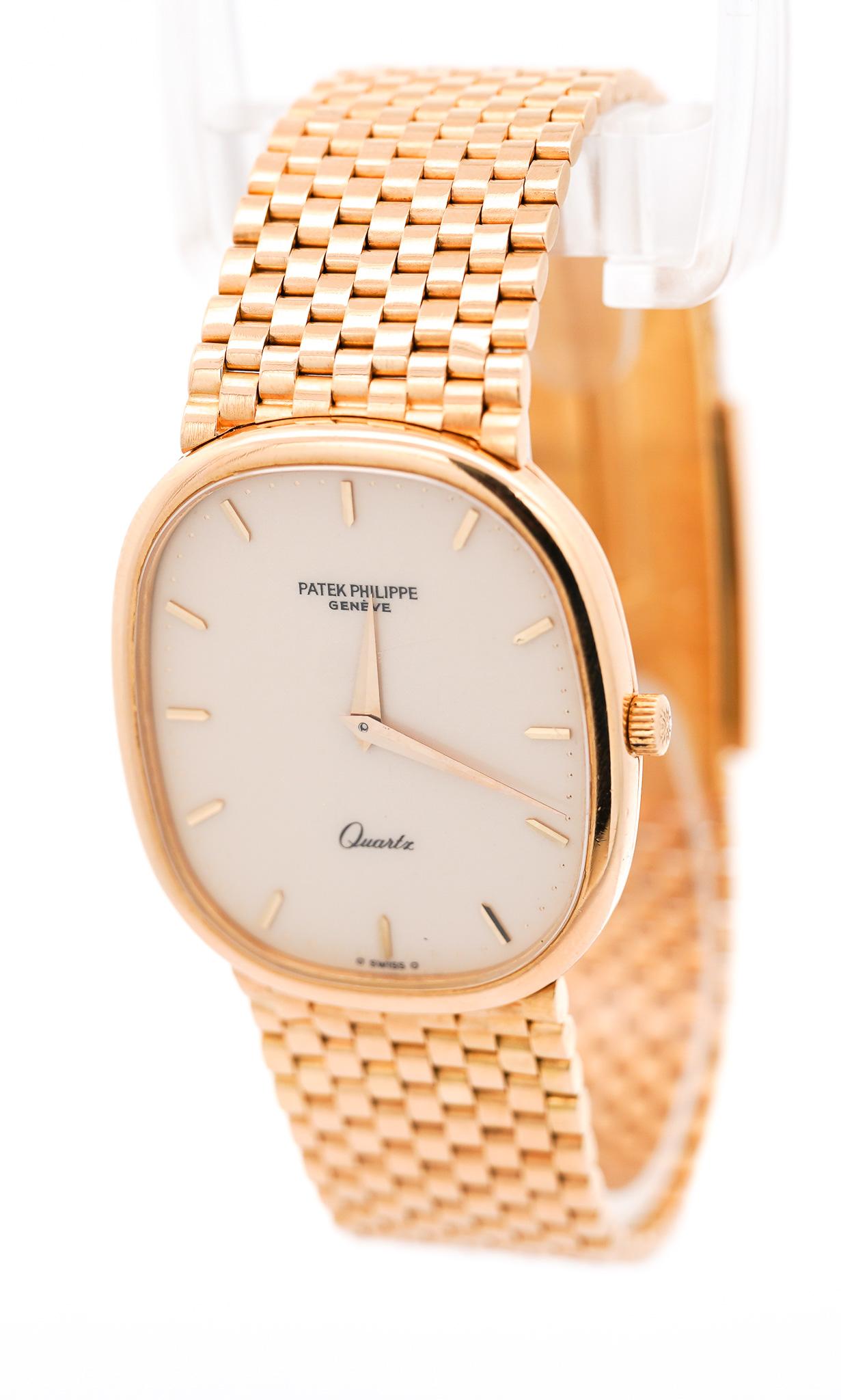 Authentic Pre-Owned Patek Philippe Grand Ellipse 3838 Unisex 18K Yellow Gold Watch. Vintage, circa 1980. Featuring a 31mm dial with a smooth gold bezel, cream-white ivory enamel dial, raised gold button hour markers, and Dauphine hands. Perfectly