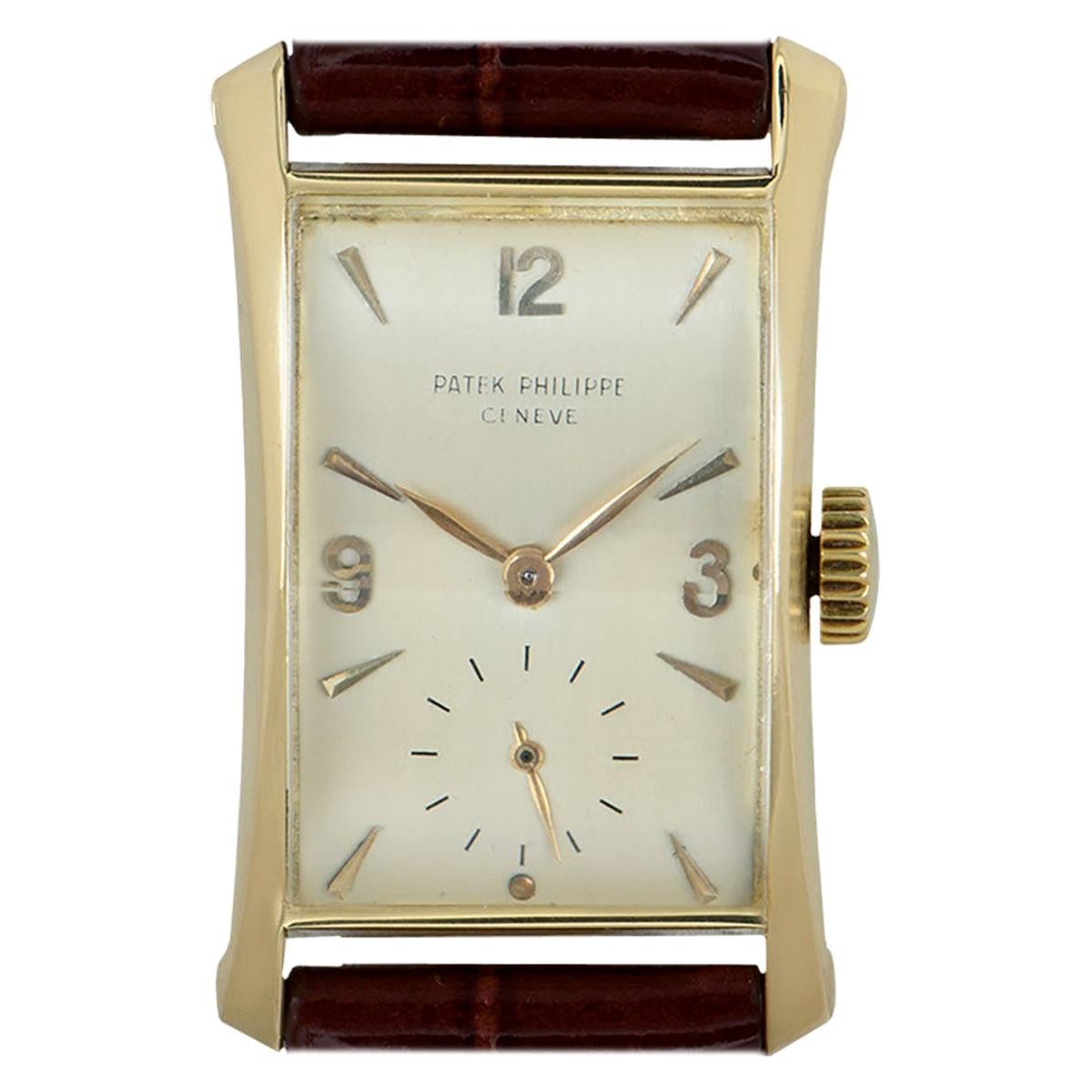 This 22 mm vintage Patek Philippe Hour Glass in yellow gold is in fine condition. Features a silvered dial with a small seconds display at 6 o'clock. A brand new generic brown leather strap comes with a gold plated pin buckle. Fitted with faceted