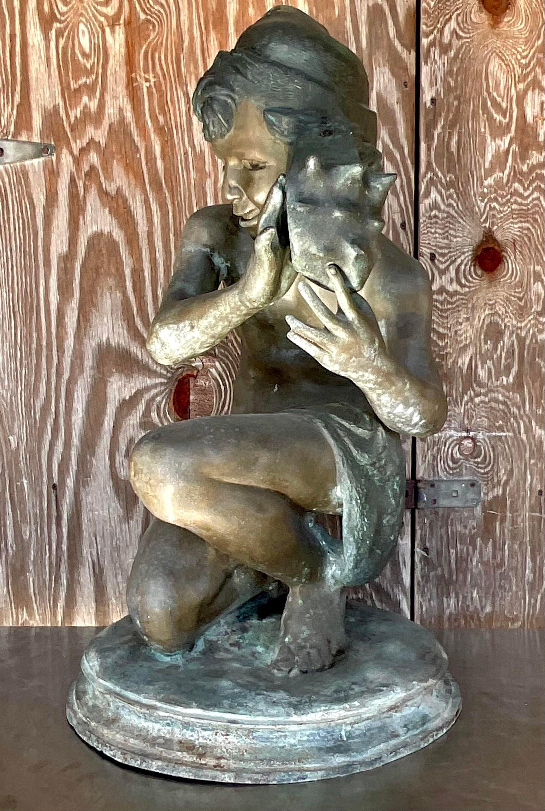 A fabulous vintage Coastal sculpture of young man with shell. Done by the iconic Jean- Baptist Carpeaux. A bronze figure with a beautiful patina from time. Signed on the pedestal. Acquired from a Palm Beach estate.