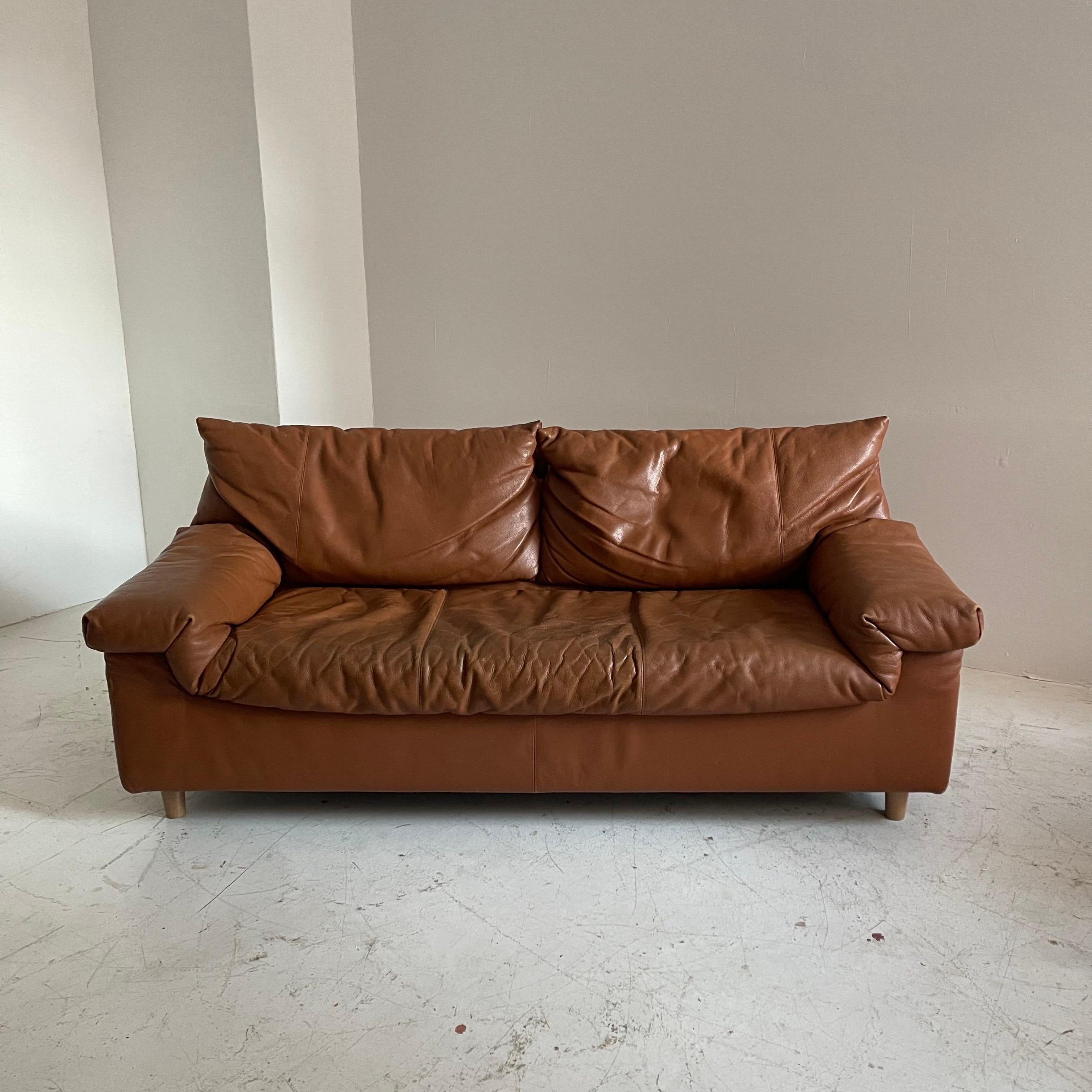 Vintage patinated Cognac leather three seater sofa by Cinna, France, 1970. Color is a dark cognac, burnt orange.
