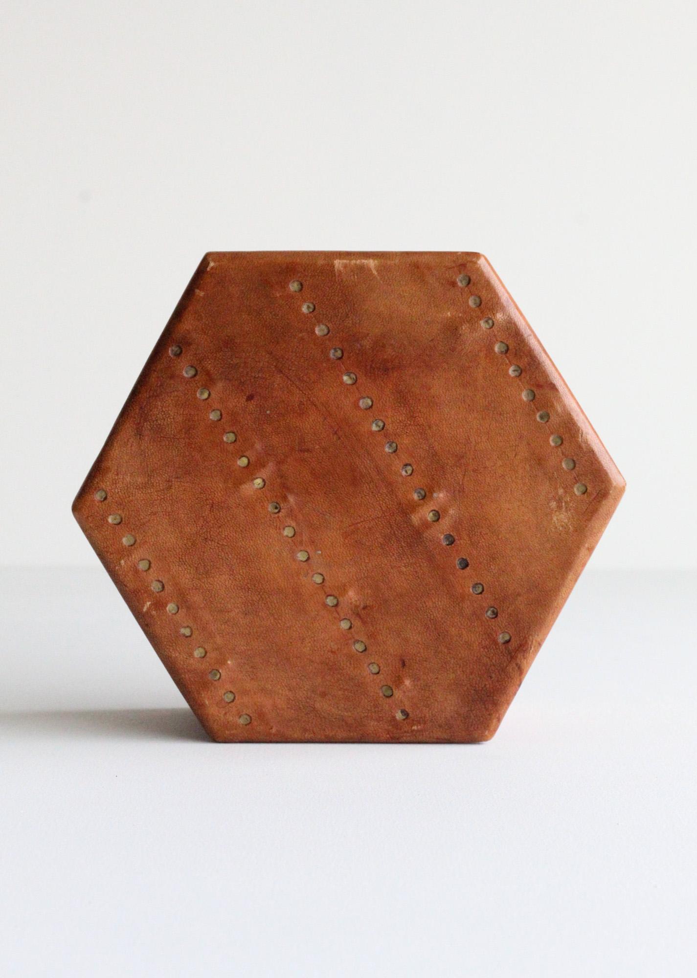 Meticulousy crafted hexagon saddle leather box with brass. Box has great patina and craftsmanship, missing a small top hinge as pictured which is an easy repair by adding or removing bottom hinge and leaving as a lidded box with vintage back hinge