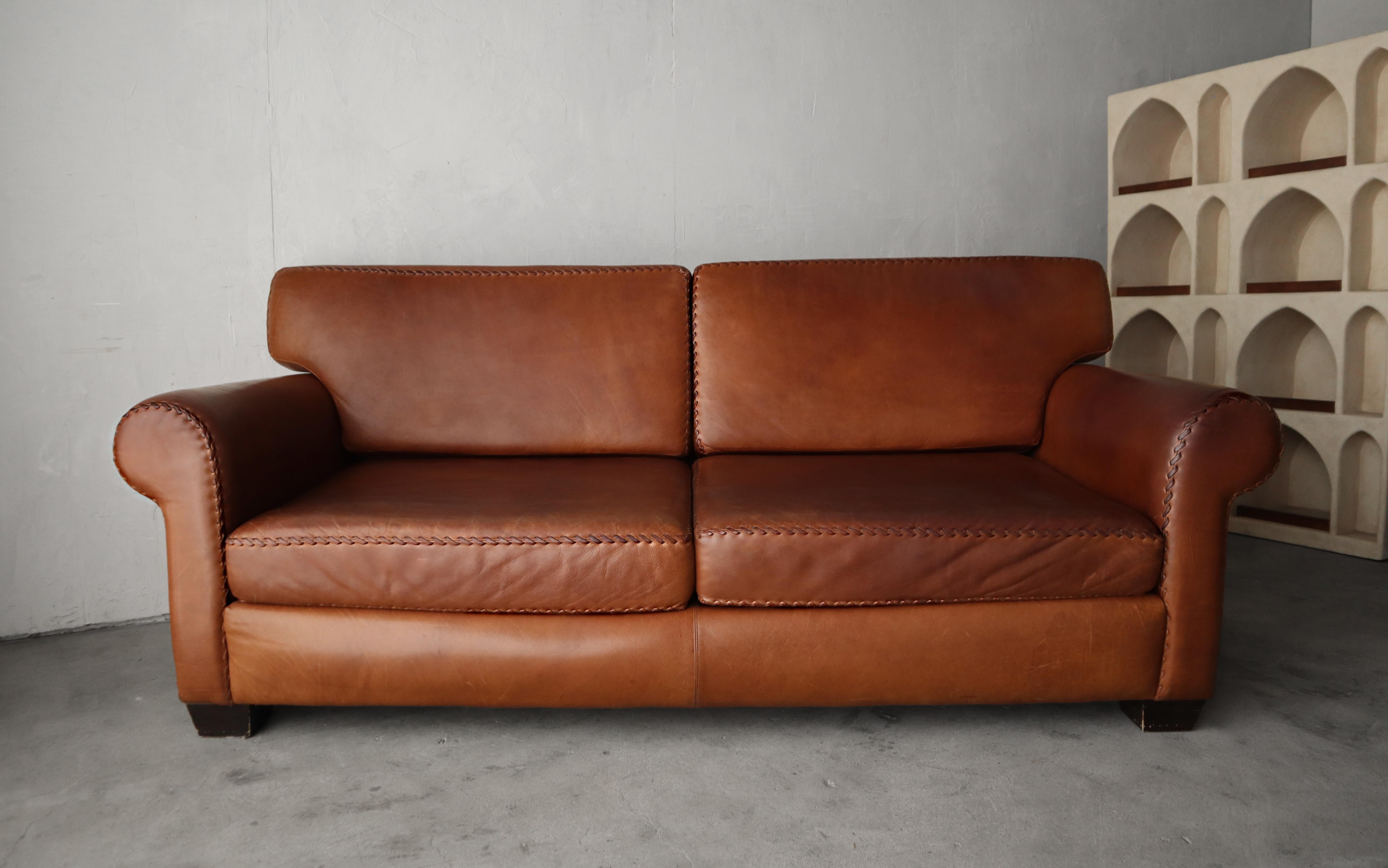 When the patina and small details makes the piece. This incredible patinated leather sofa is ready for its next life. I love the look and feel of the butter soft patinated leather, and the chunky baseball style stitching throughout.

The sofa is