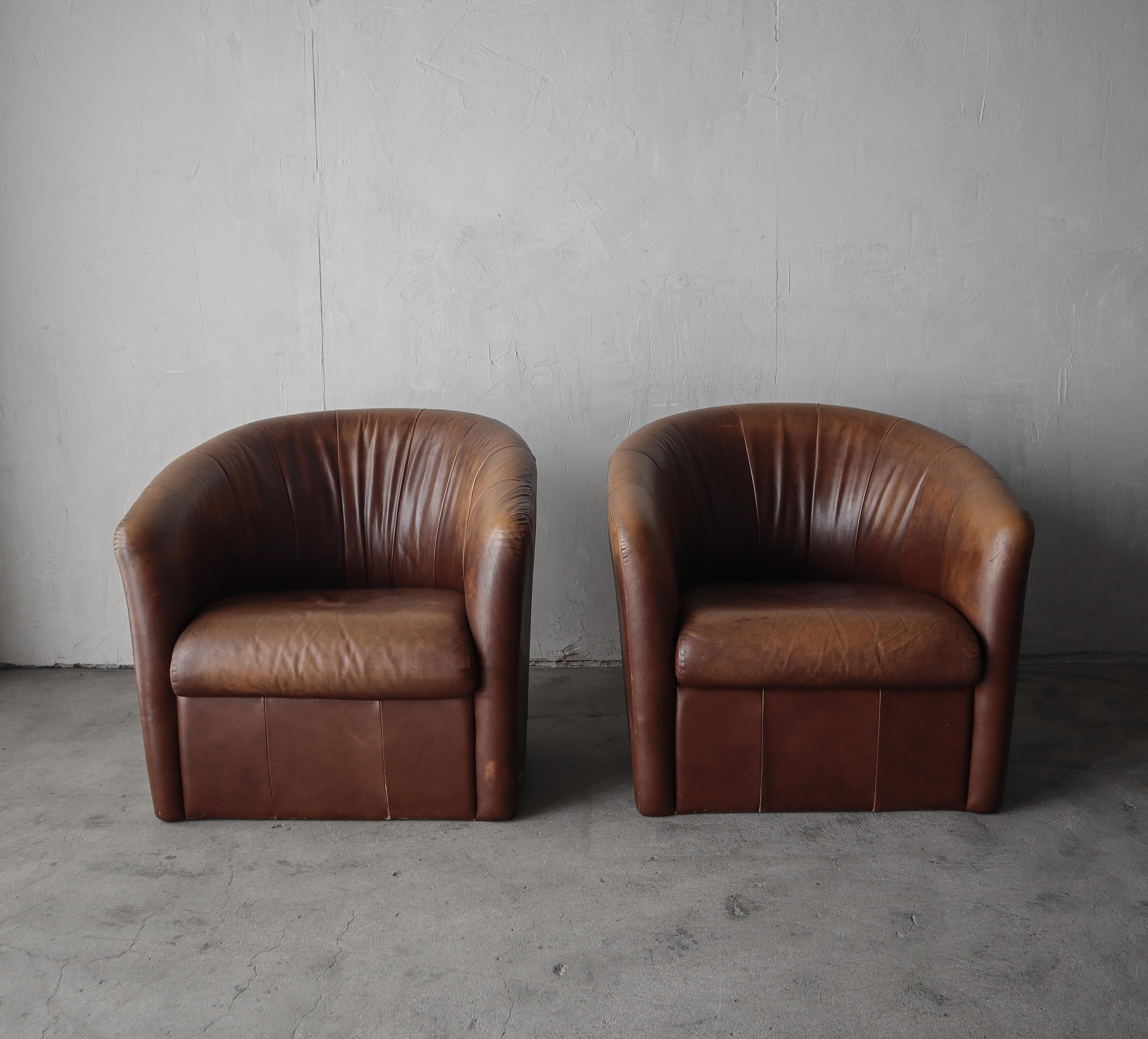 A beautiful pair of properly patinaed leather club chairs.  If you've been looking for a hardy dose of leather character to add to your eclectic space or man cave, look no further, these guys are oozing. 

The chairs are structurally sound and very