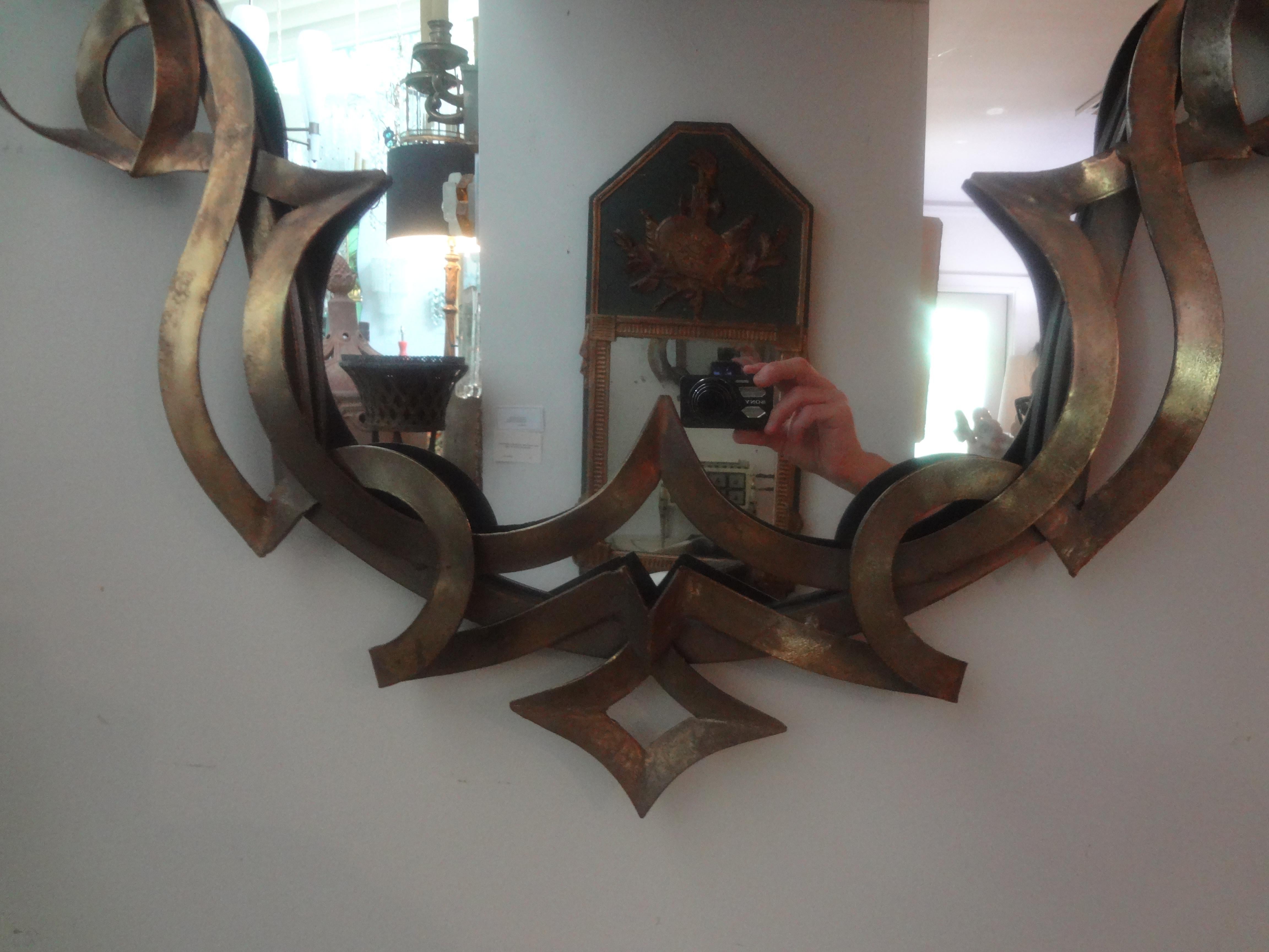 Miroir vintage en métal patiné avec ruban.
Ce miroir chic en métal patiné du milieu du siècle dernier présente un design en ruban entourant un panneau central en miroir.
Notre miroir inspiré de Gilbert Poillerat est parfait pour un hall d'entrée