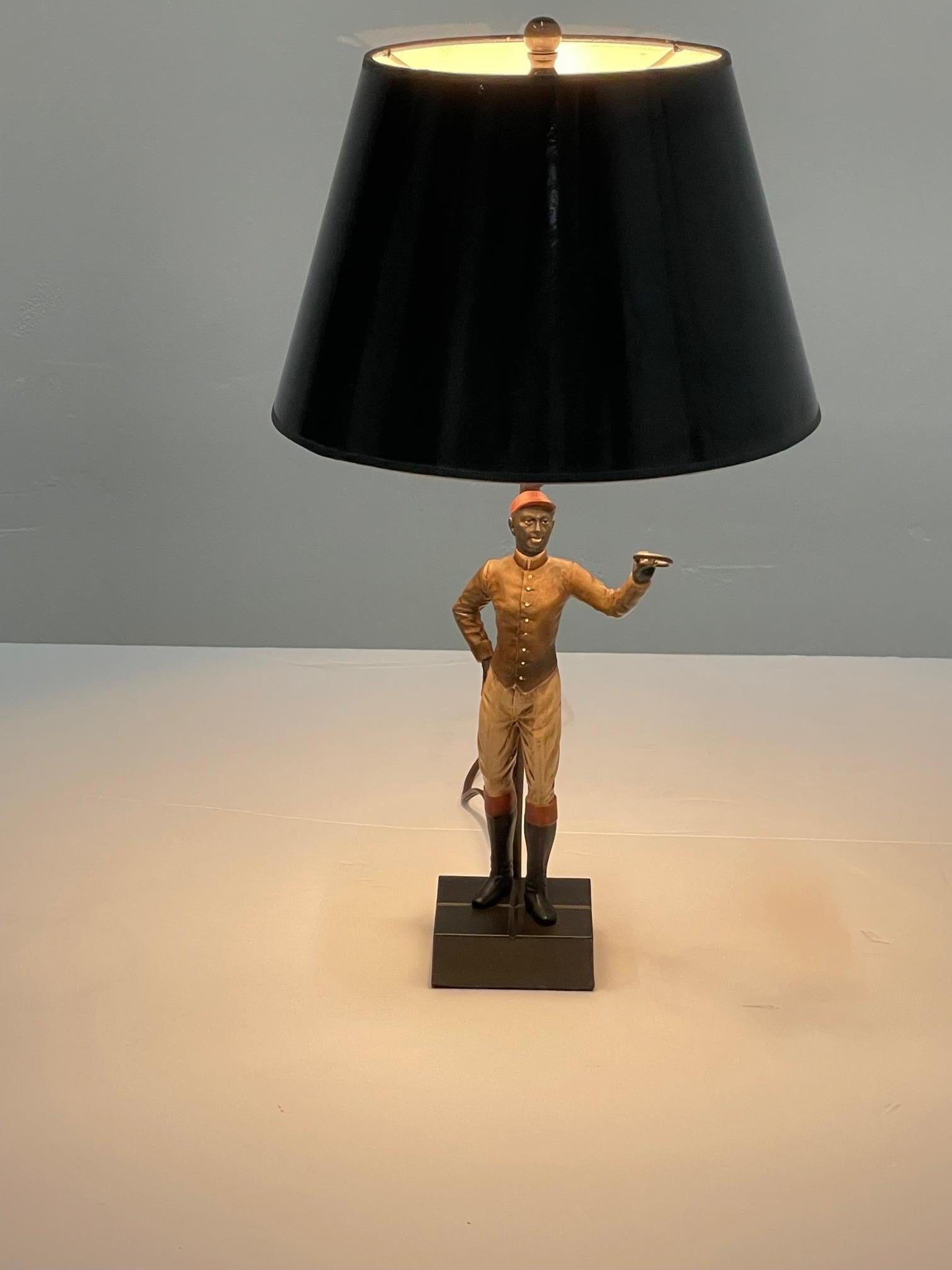 A statuesque well outfitted jockey with red hat and high boots is the sculptural column of this sporty table lamp.
Sculpture is 6
