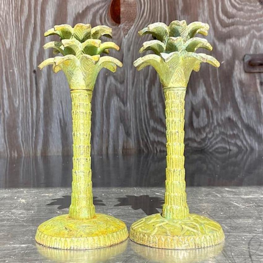 A charming pair of vintage Coastal Palm Tree candle sticks. A gorgeous patinated green finish on a classic palm tree design. Sure to add a flash of tropical beauty to any space. Acquired from a Palm Beach estate