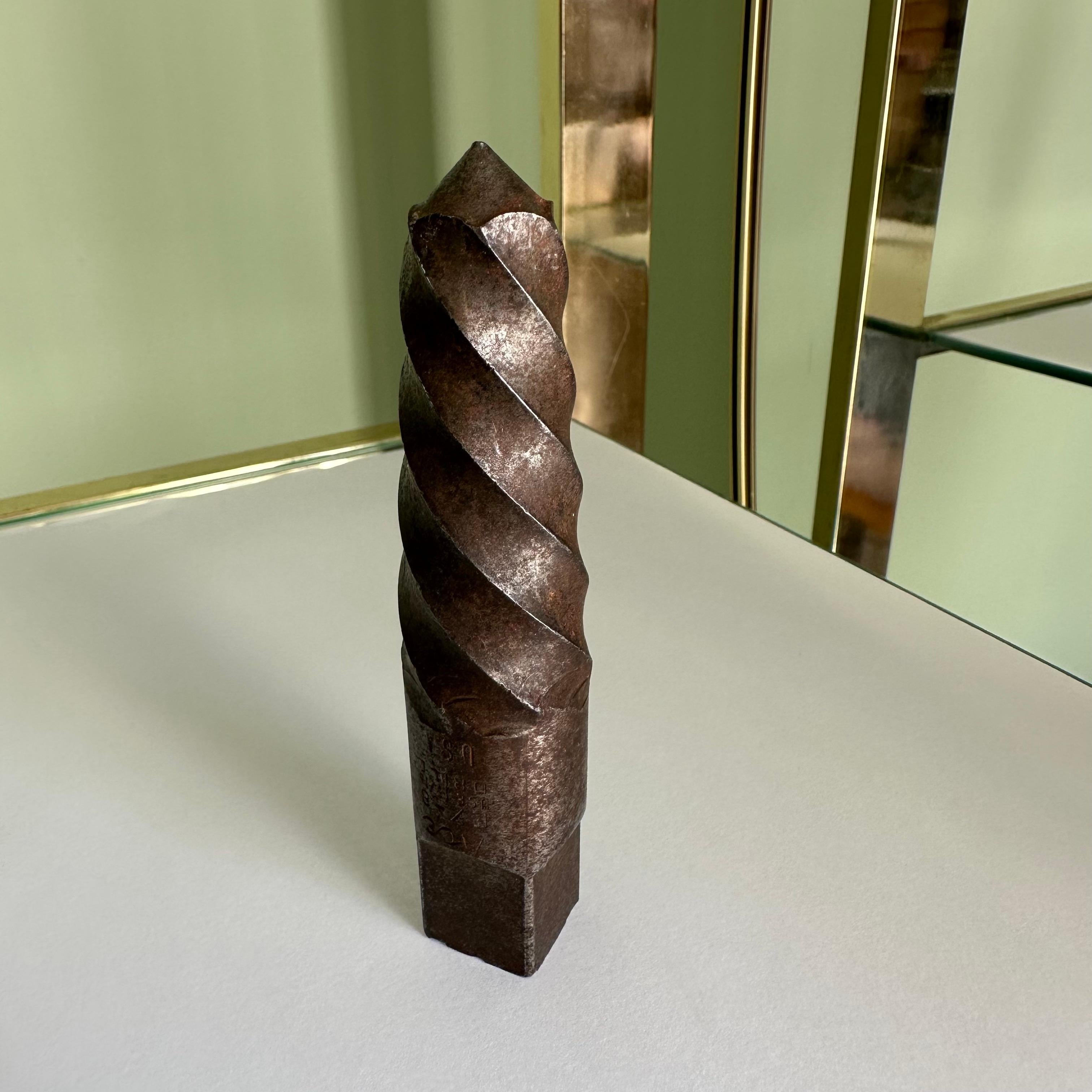1970s pipe extractor bit with amazing patina used as a paperweight. Conical in shape with sculptural threading, this piece is great as a masculine desk object or accessory. 

From the estate of an NYC 1970's master plumber. 
