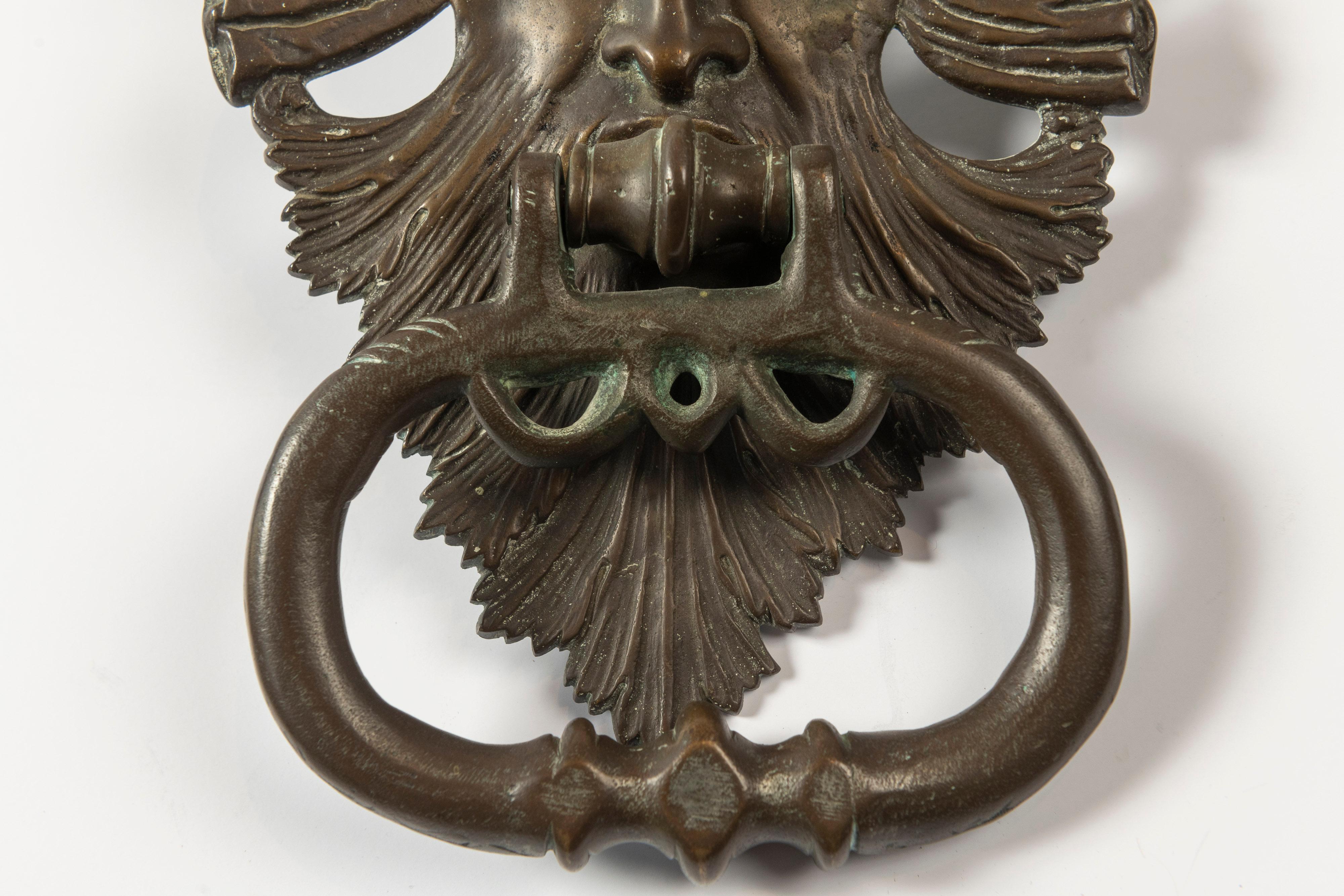 Impressive solid brass door knocker presumed to be of the ancient Roman mythological god of the sea, Neptune. The piece is in excellent condition and ready to adorn your door while making a classical statement.